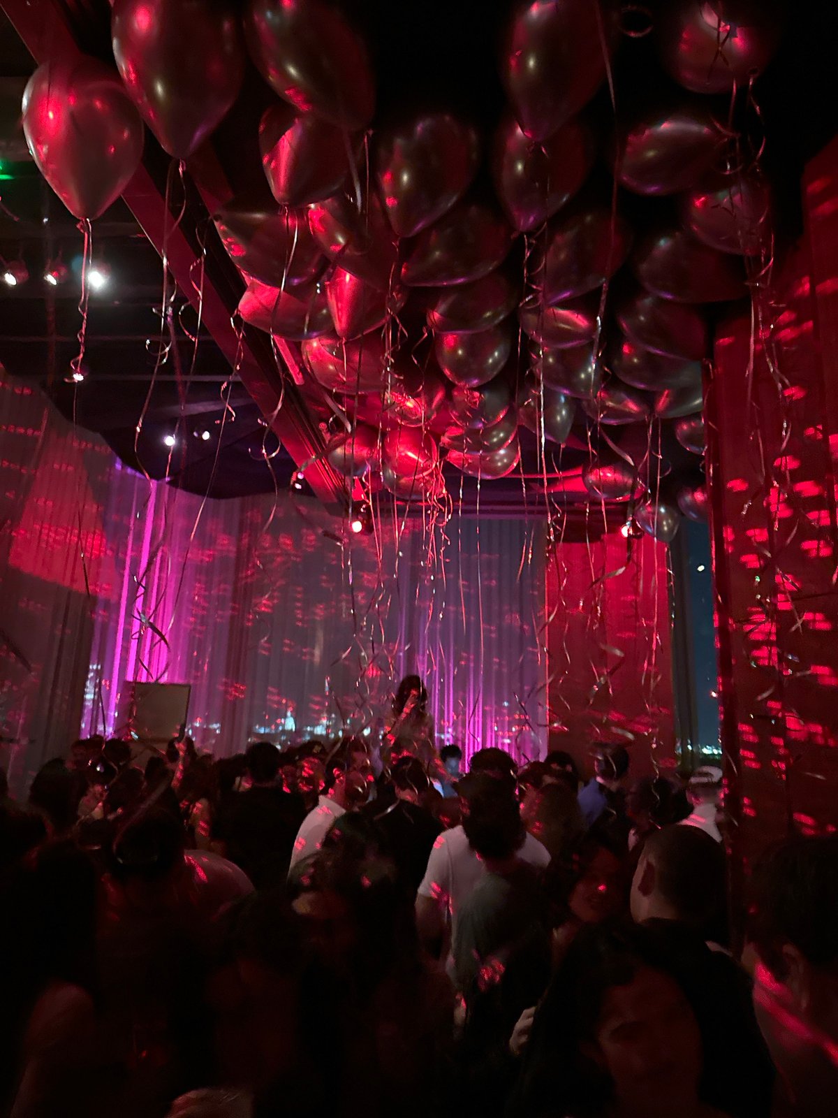 London bar observed with moody lighting and balloon decorations