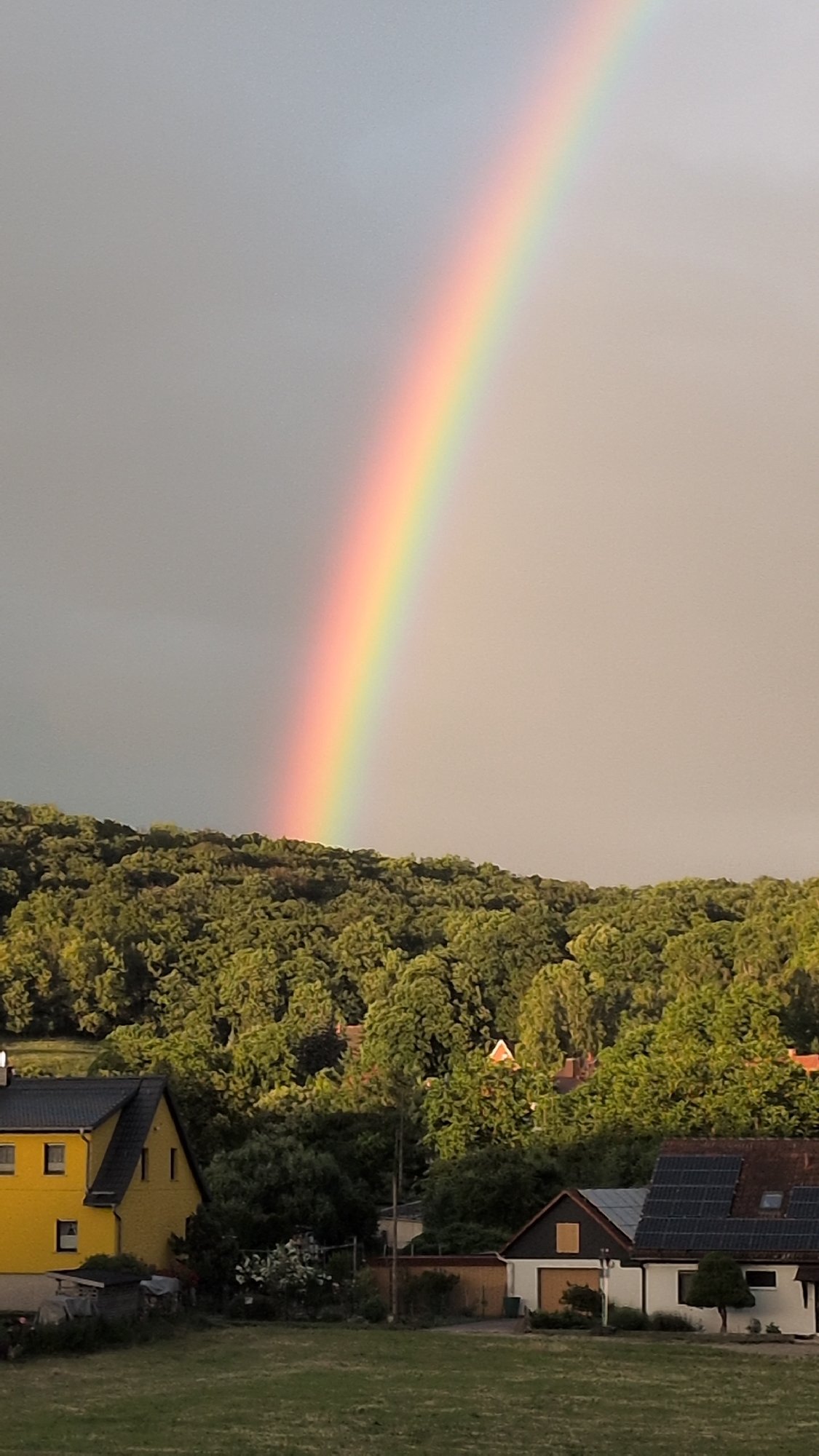 Rainbow over Rastenberg with garden watering and candy bowl