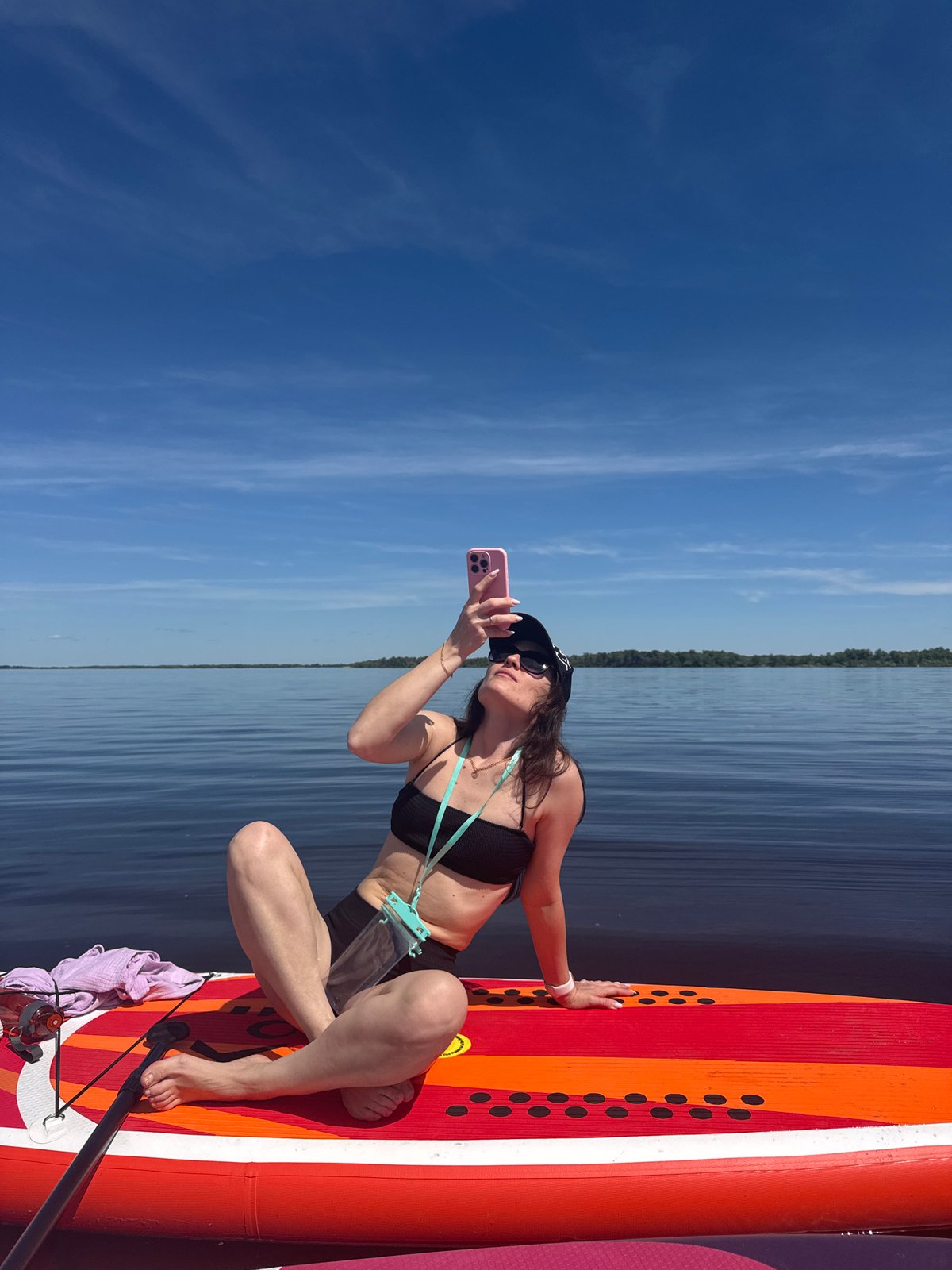 Women paddleboard on calm waters near Усть-Курдюм, Russia