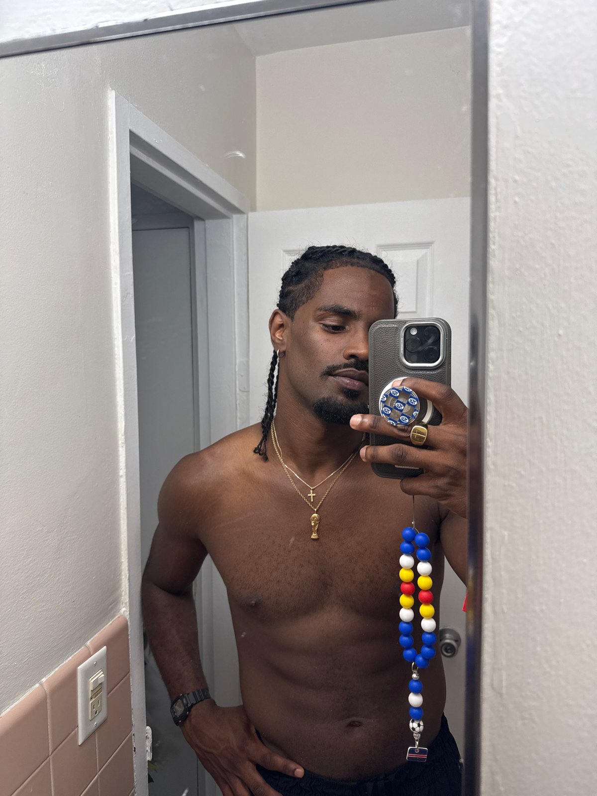 Bathroom mirror selfie with gold chain in Hollywood, FL
