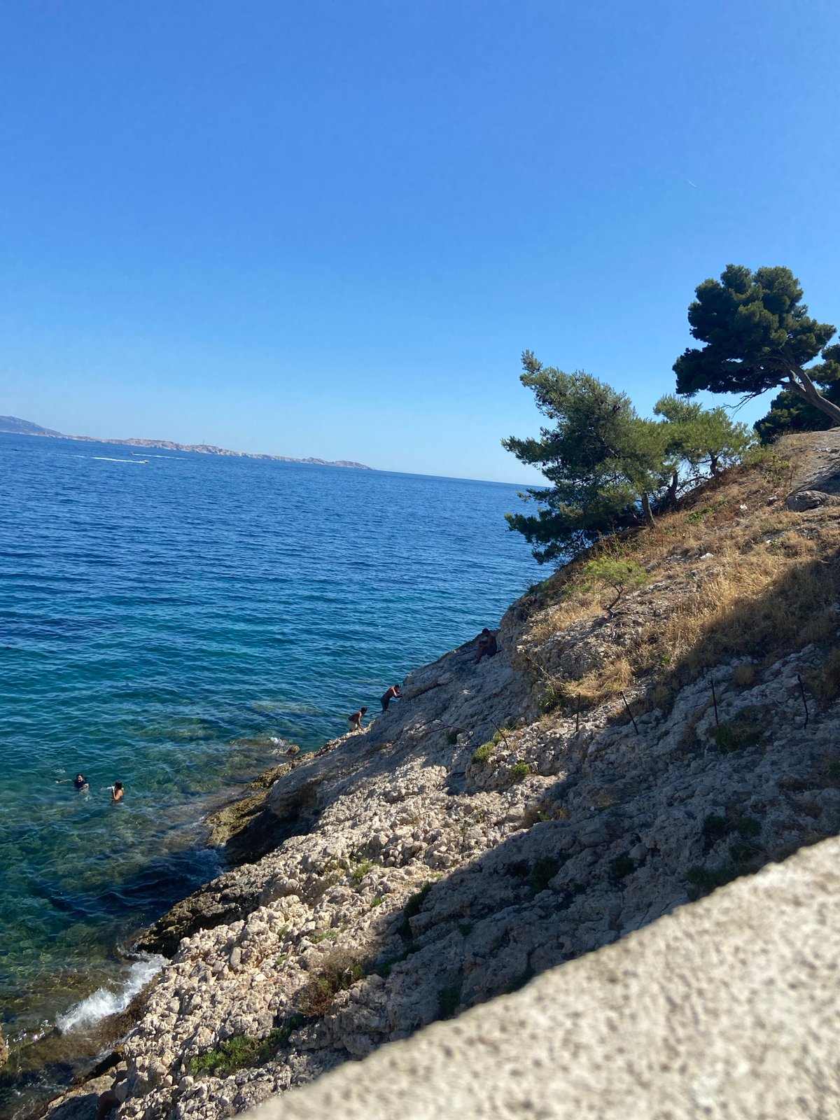 Rocky Mediterranean coast and ancient aqueduct on a clear summer day