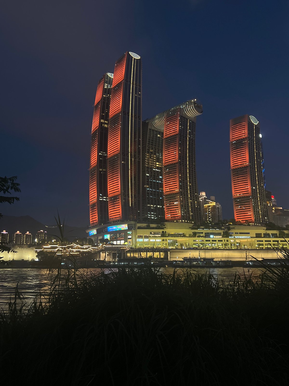 Chongqing's Yuzhong District riverfront glowing on a summer night