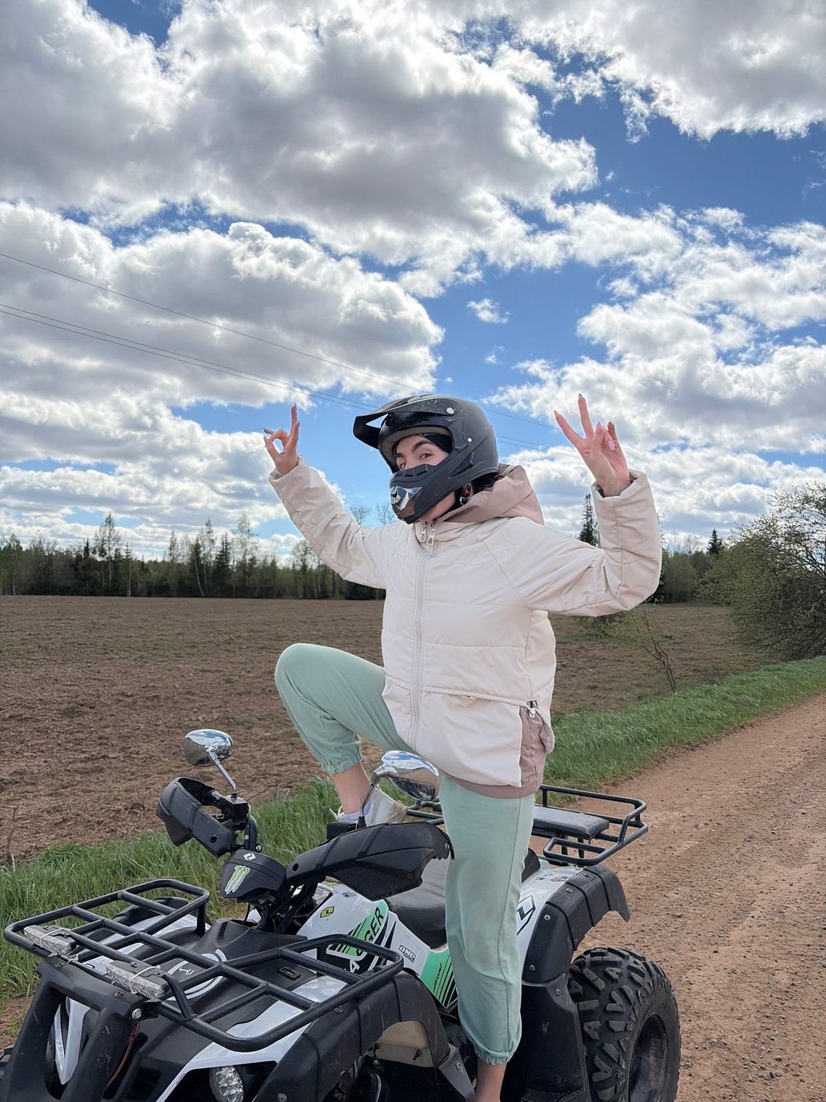 Woman poses with ATV on rural roads near Можга