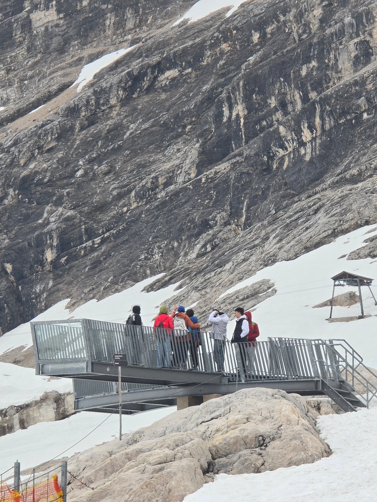 Visitor documents scenes at Zugspitze peak during midday tour