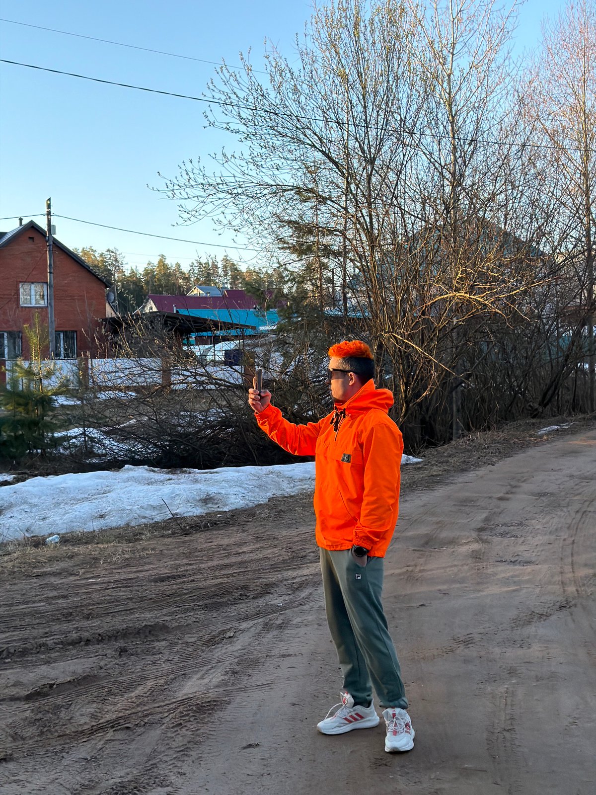 Adult and children spend time on dirt roads in Chaikovsky