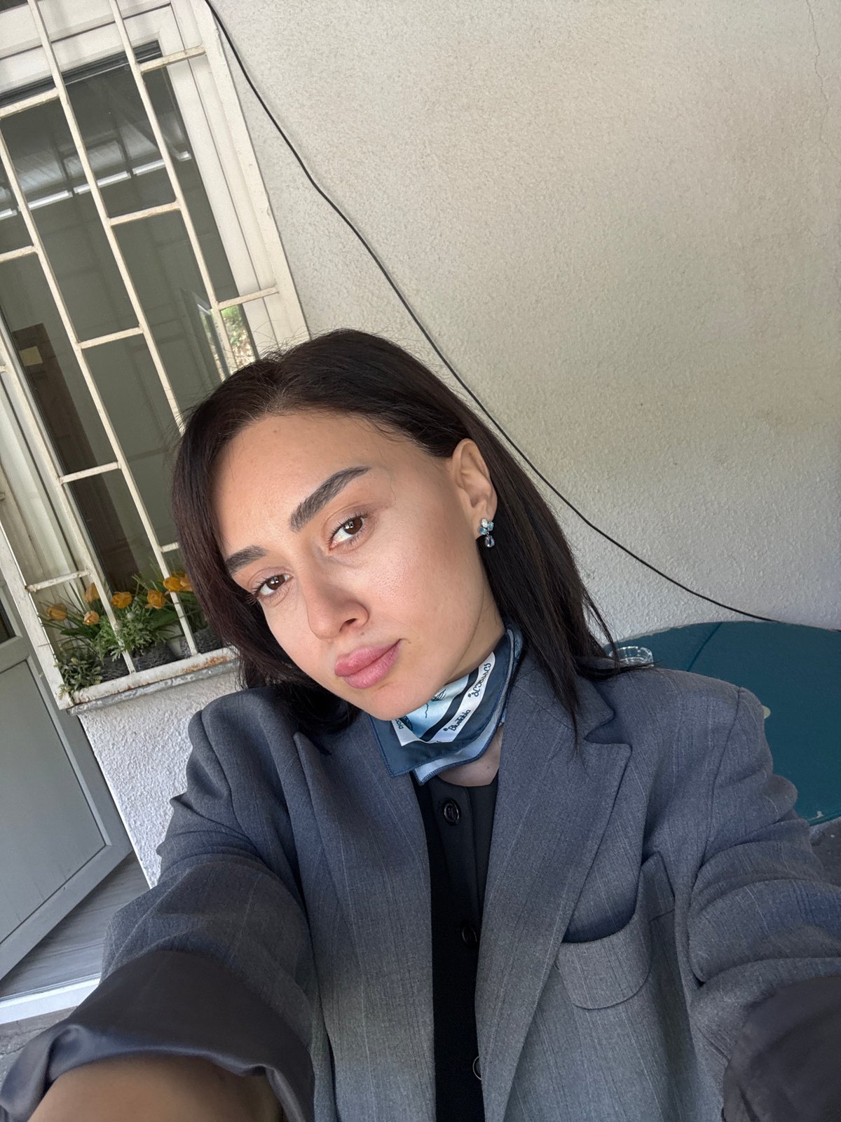 Woman in gray blazer photographed across multiple Tbilisi locations