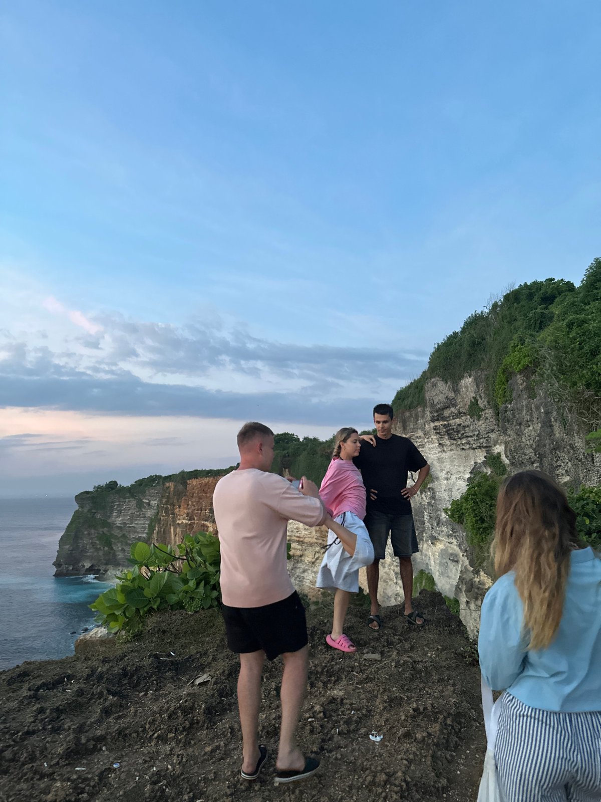Five people gather on cliffside in Kuta Selatan