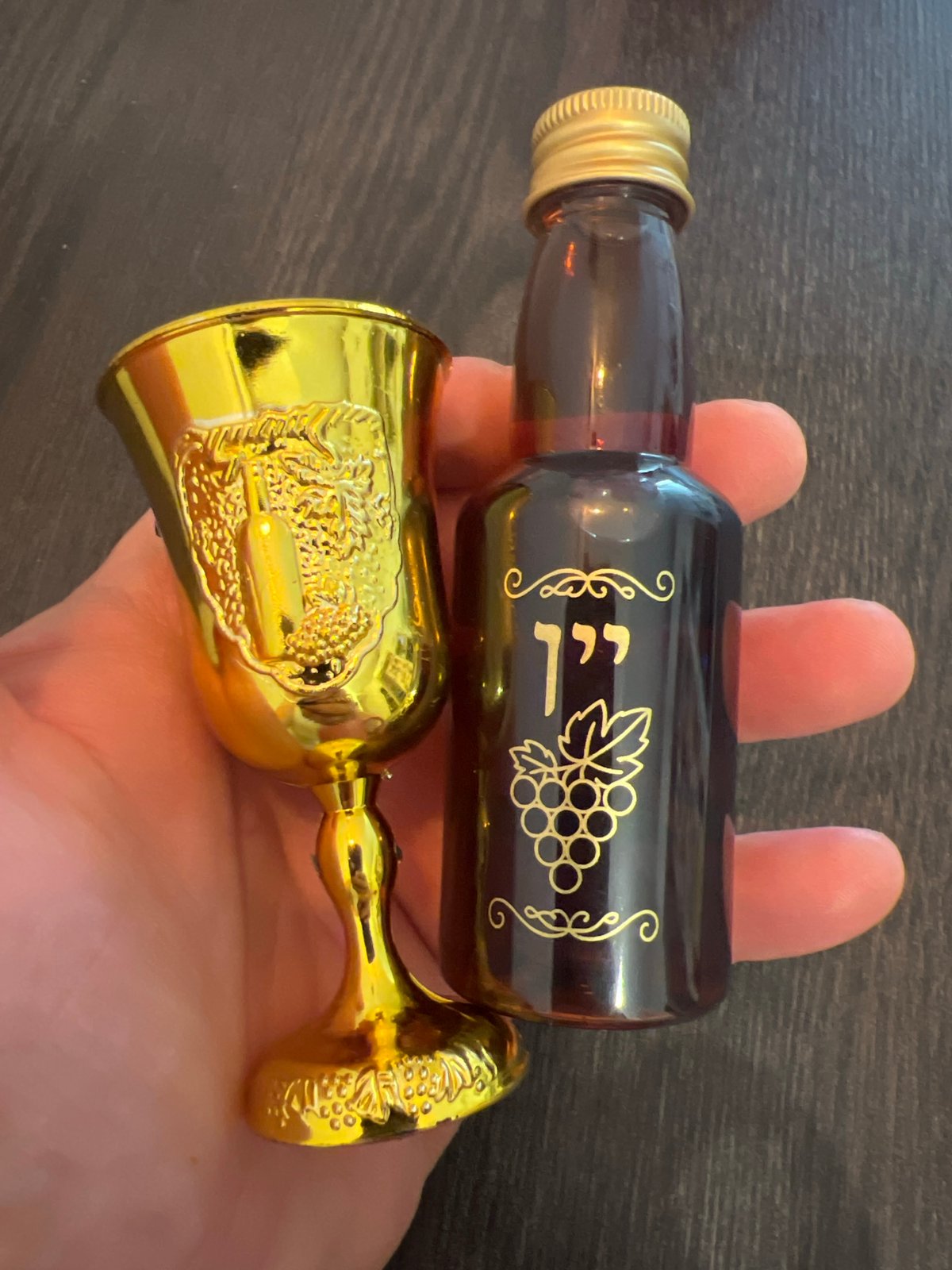 Individual displays amber bottle, golden goblet in Ramat Gan