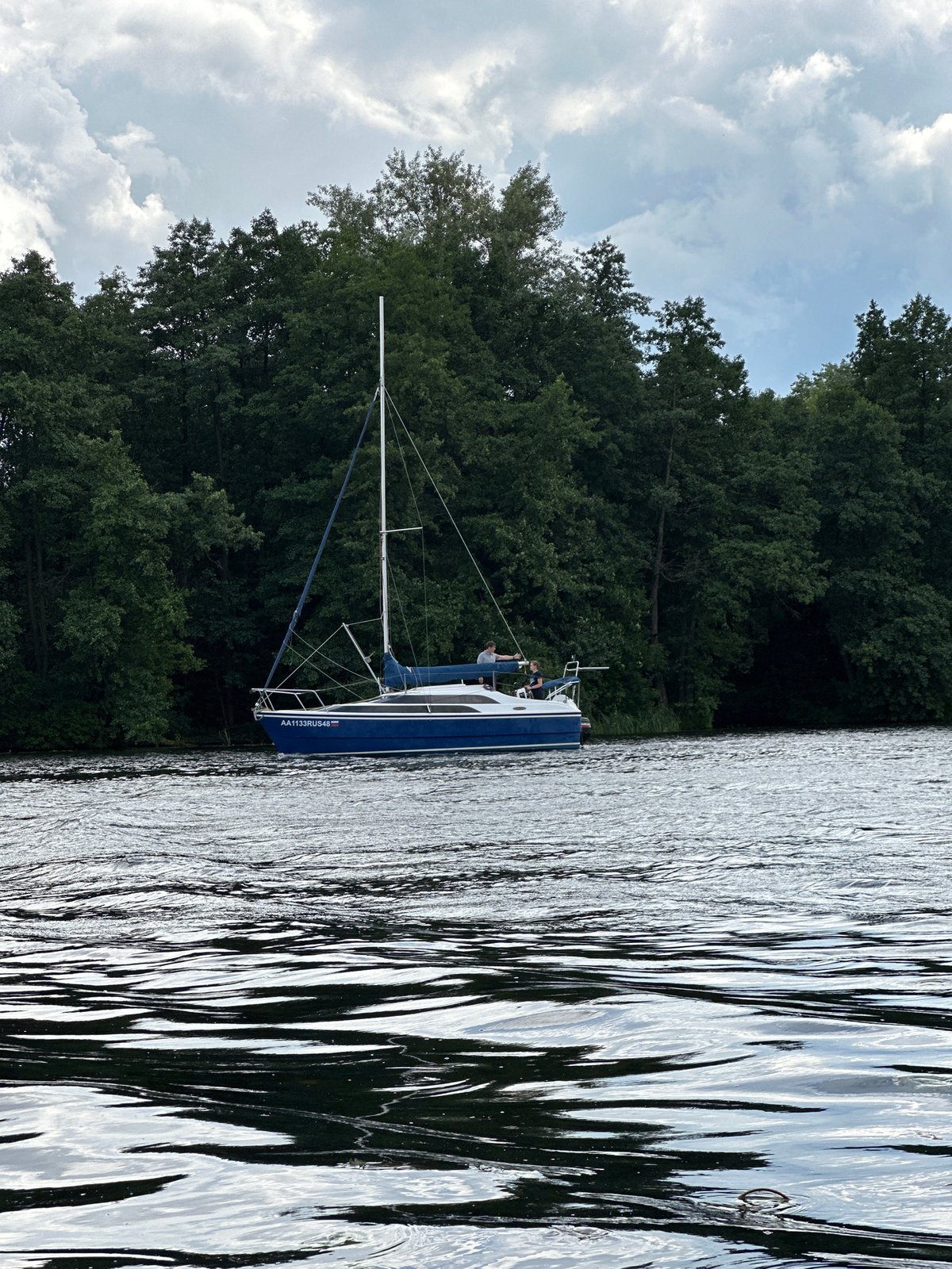 Blue sailboat anchored on a choppy lake near Lipetsk