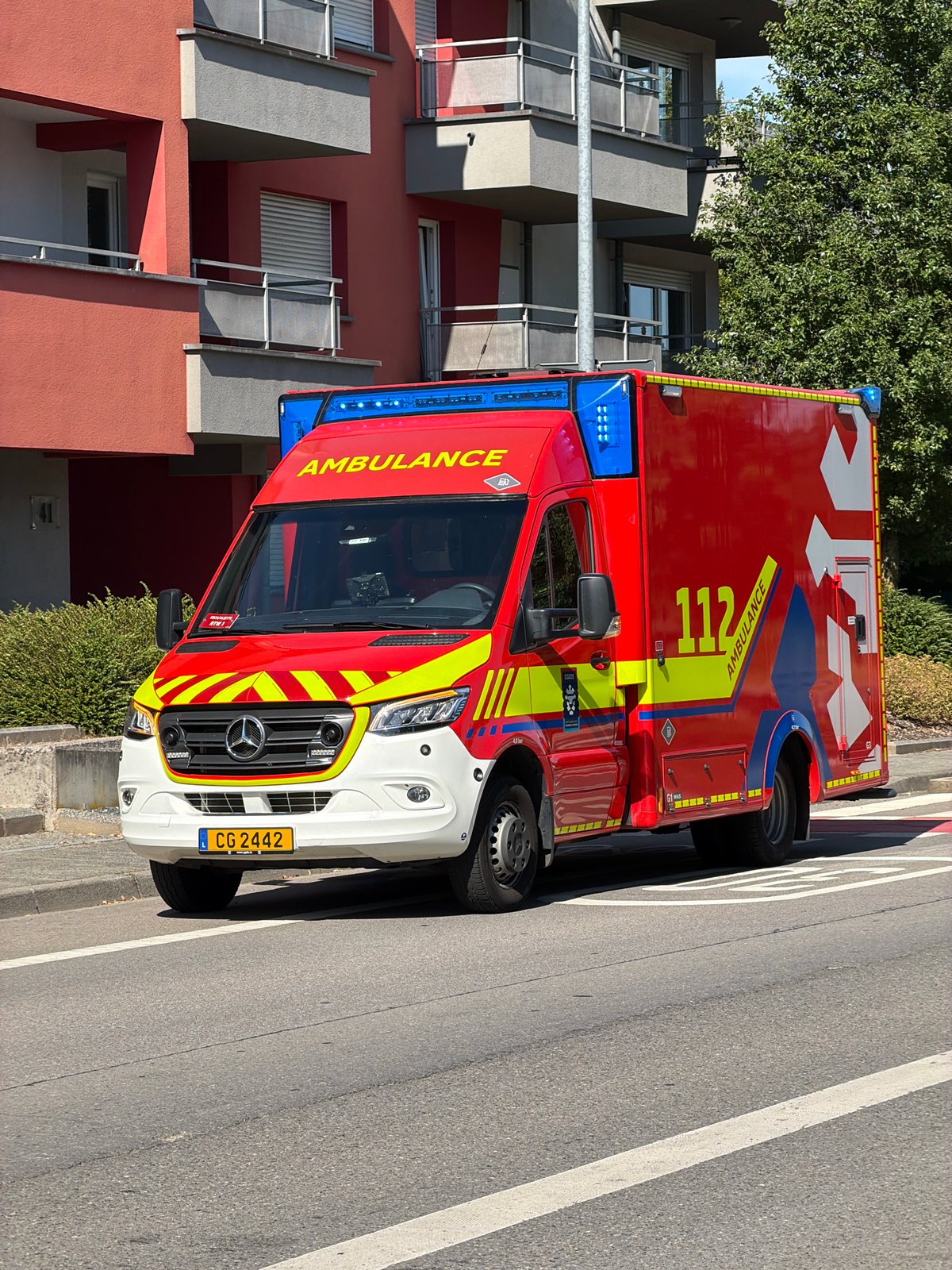 Red ambulance parked on a street in Esch-sur-Alzette, Luxembourg