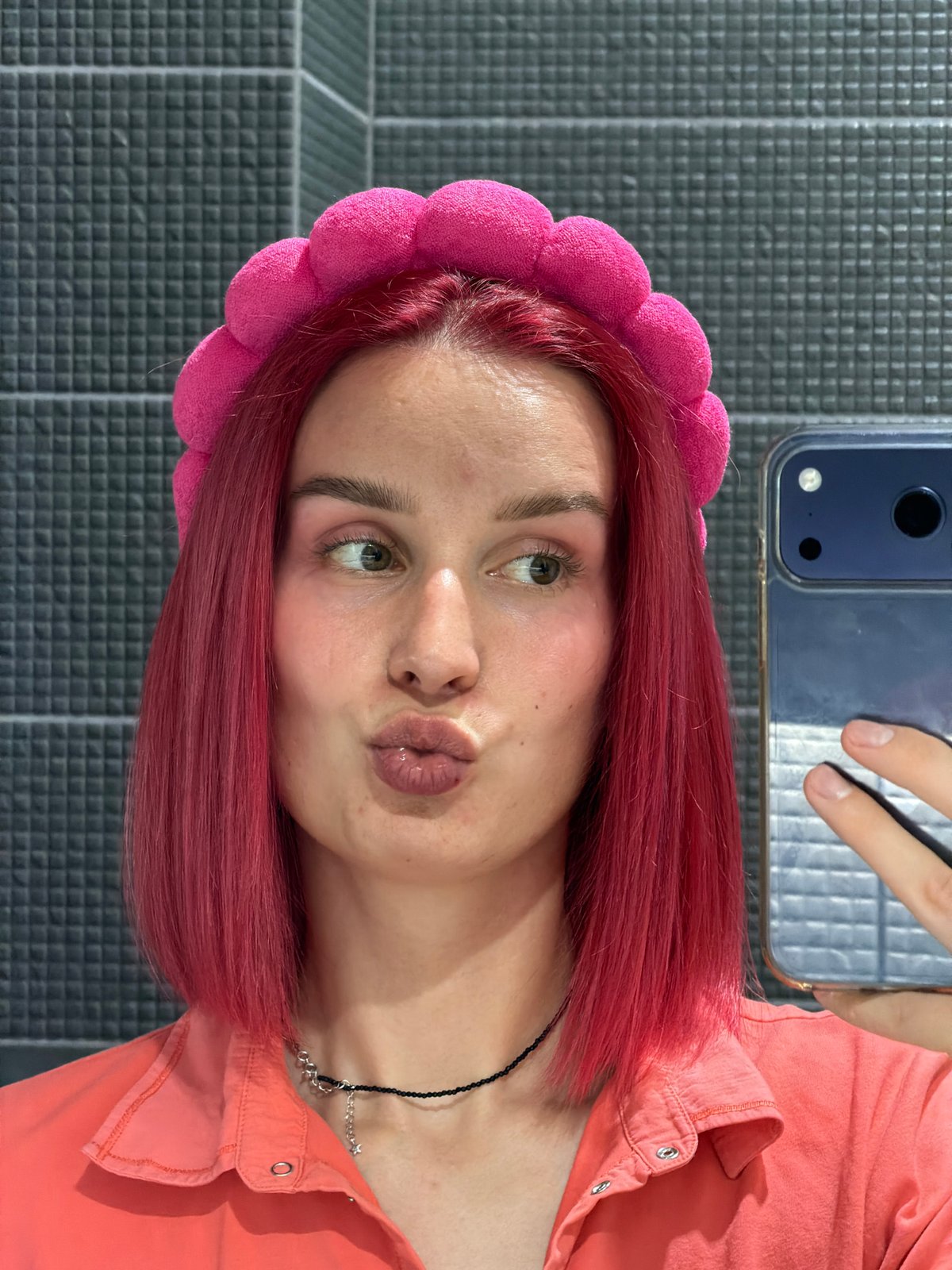 Pink-haired woman photographed indoors in Chaikovsky, Russia