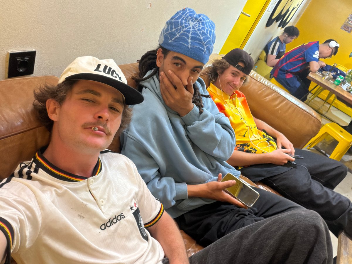 Four young adults relax on couch in Barcelona bar