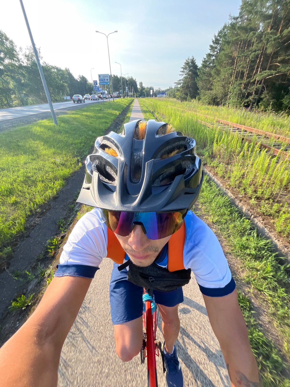 First-person cycling along a paved path in Chaikovsky, Russia