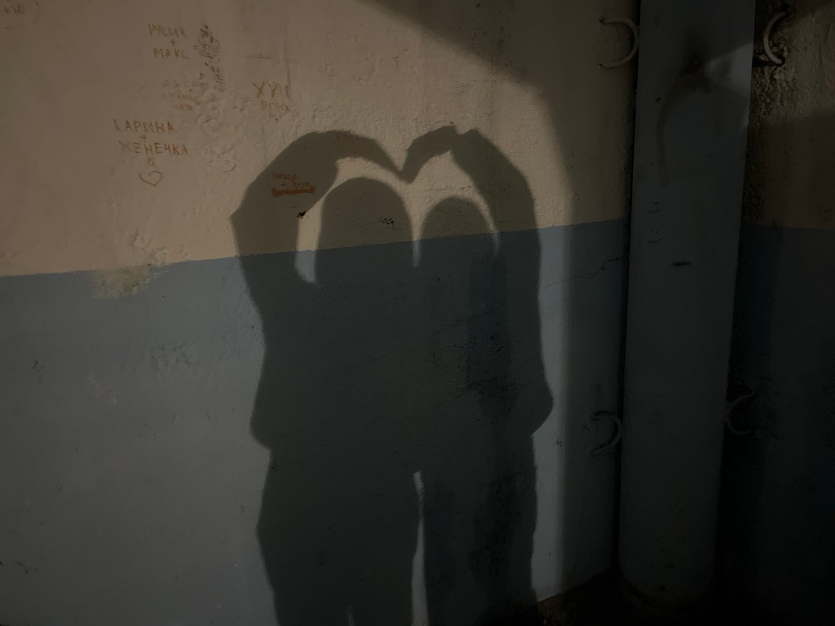 Heart shadow gesture captured on graffitied wall in Sosново