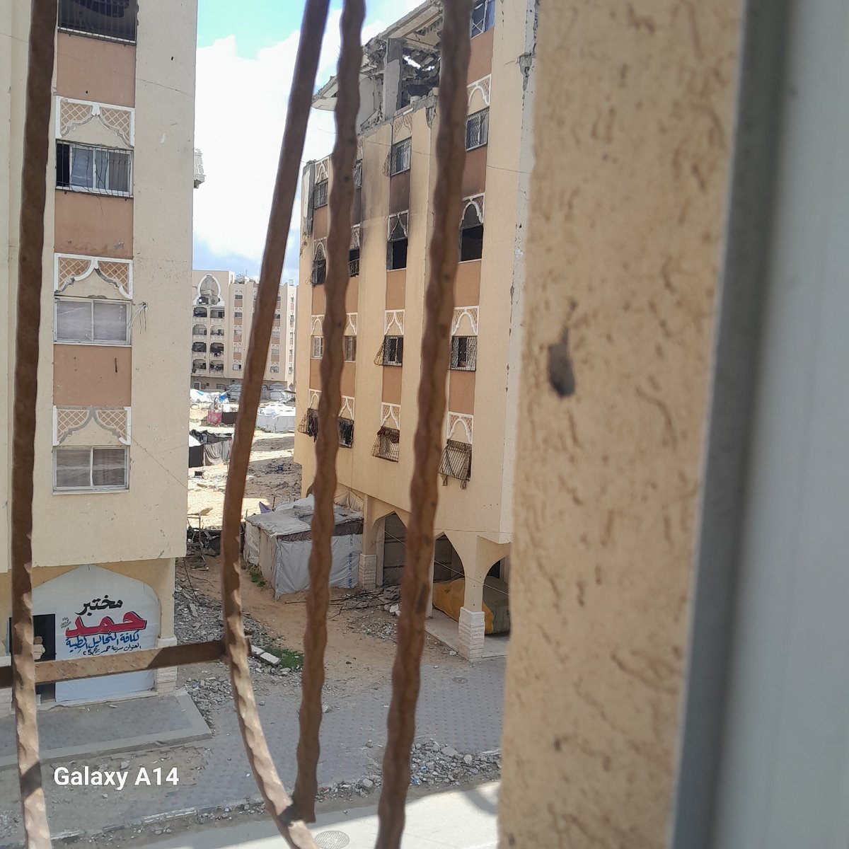 Elevated urban view shows varied architecture, possible damage