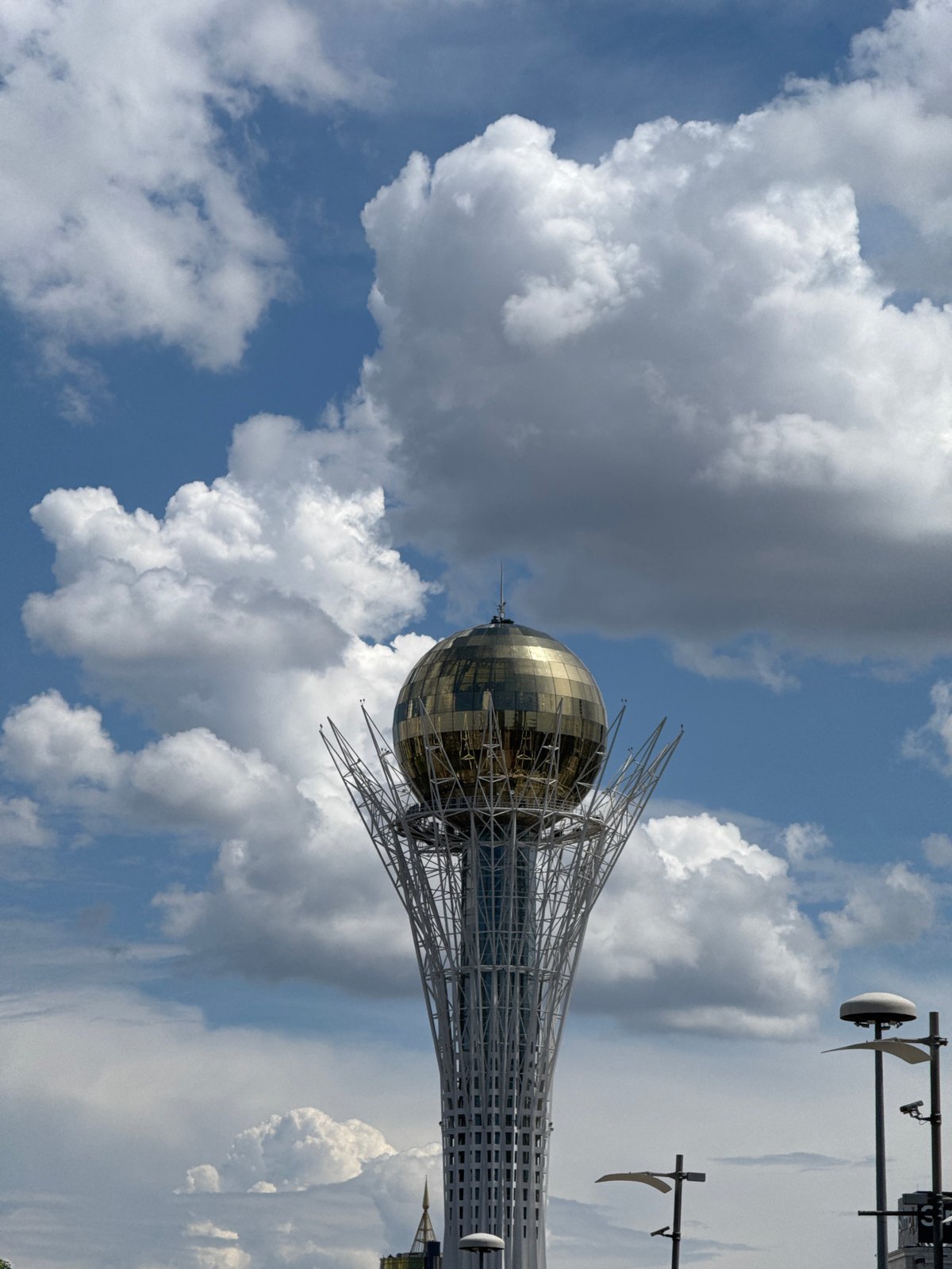 Bayterek Tower and Astana streets on a cloudy morning
