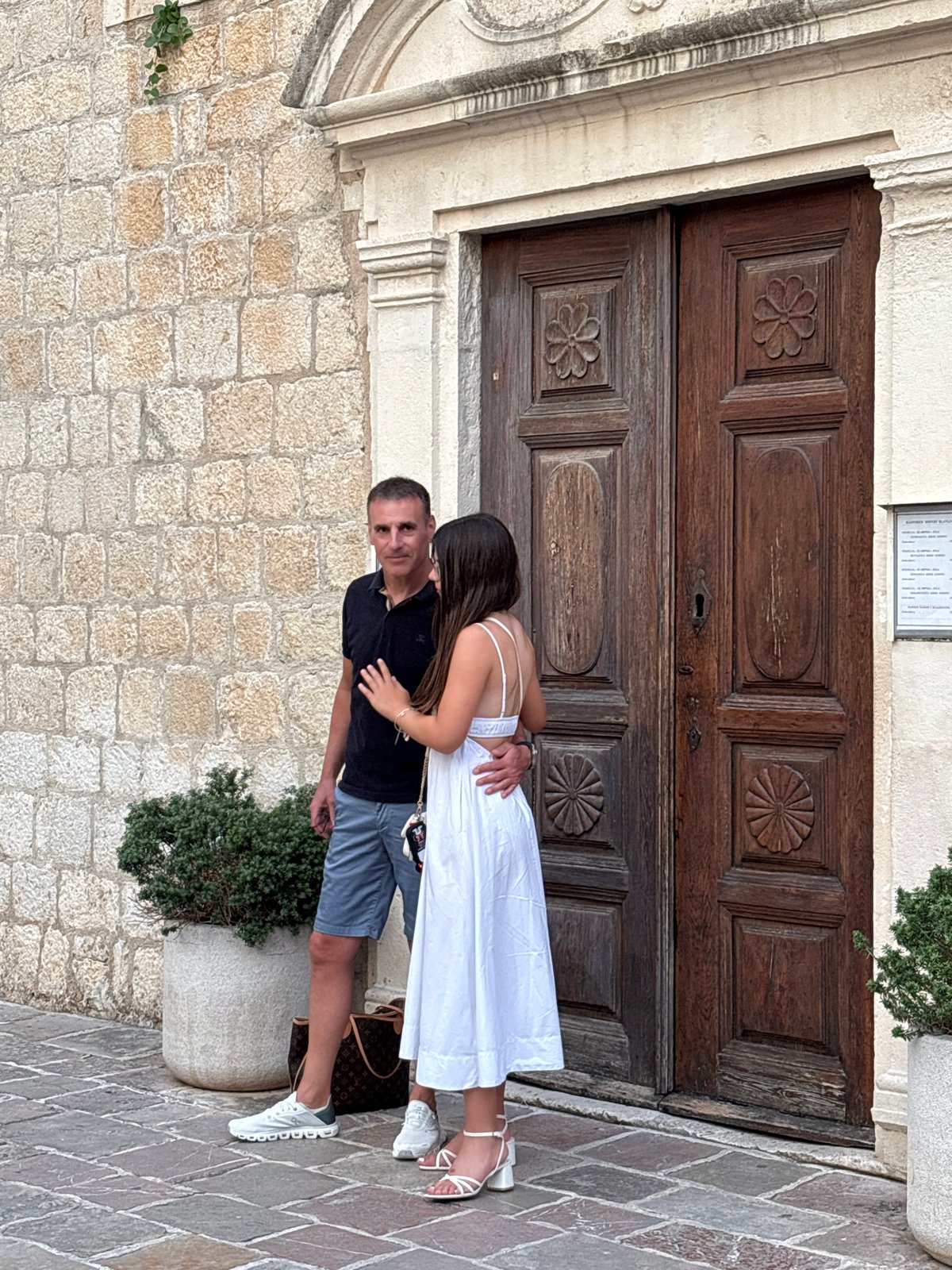 Summer afternoon on the Budva waterfront — beaches, boats, and a cat