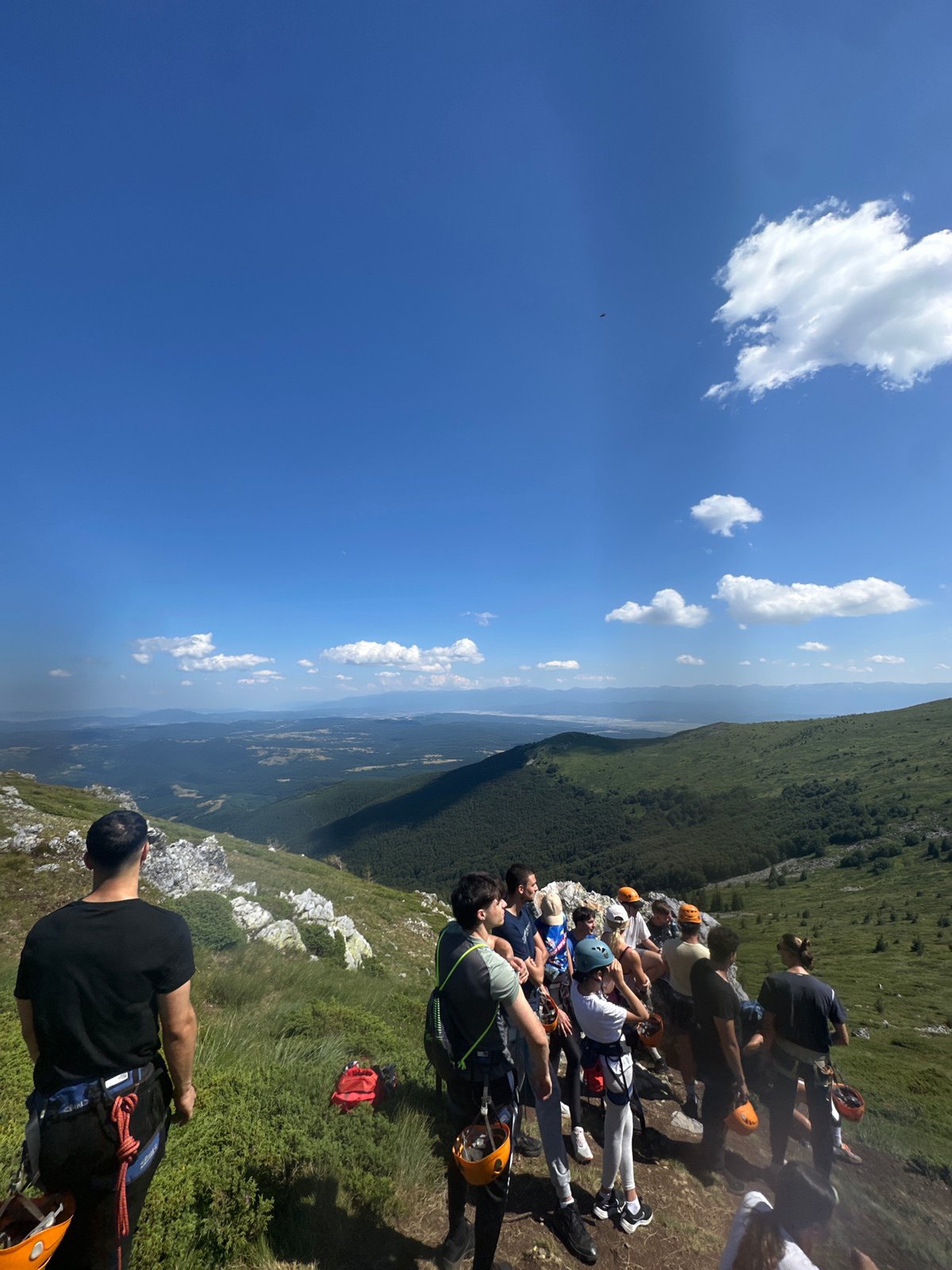 Harnessed group takes a break on a Bulgarian mountainside