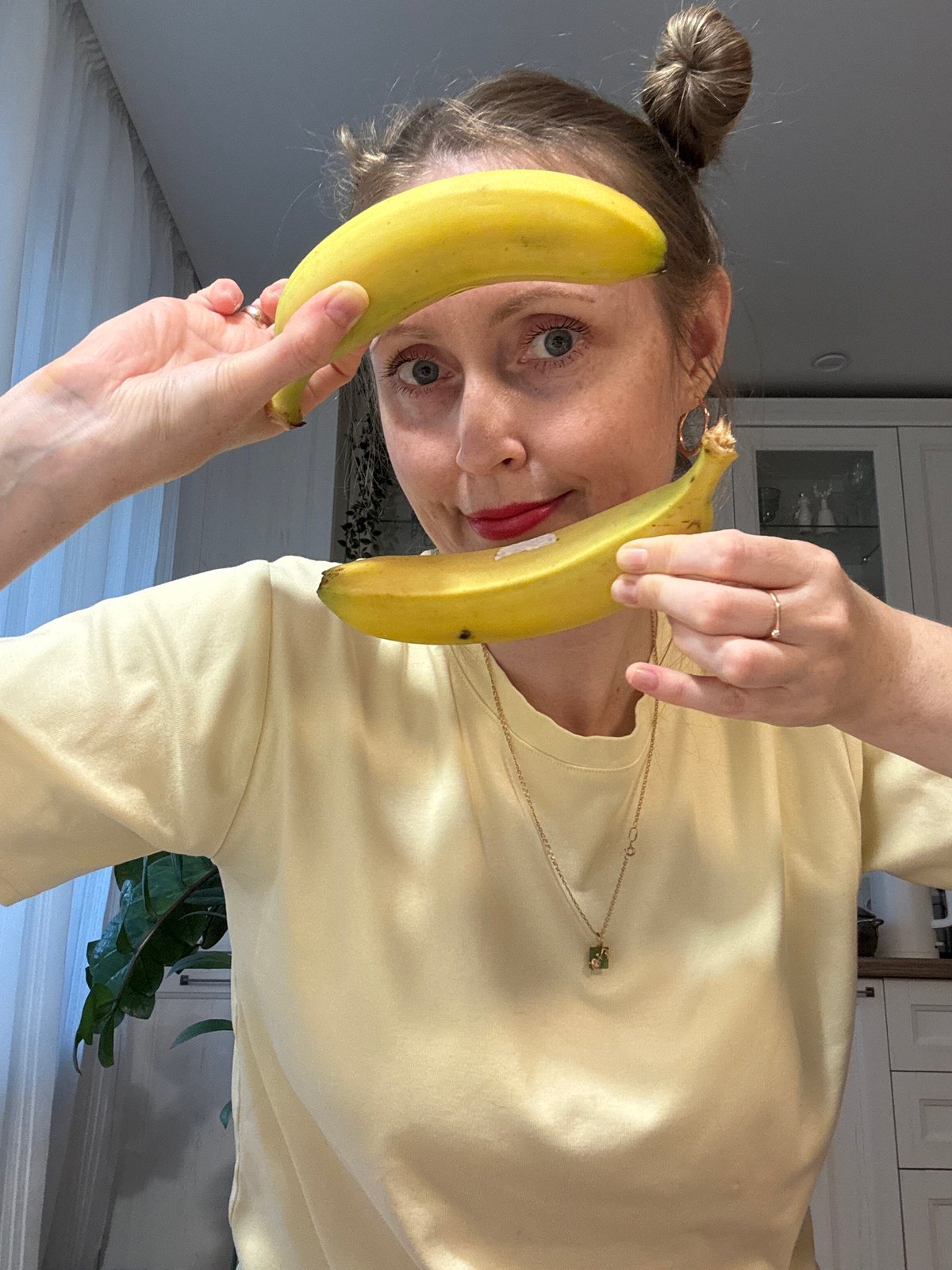 Woman and child play with fruit in Russian kitchen
