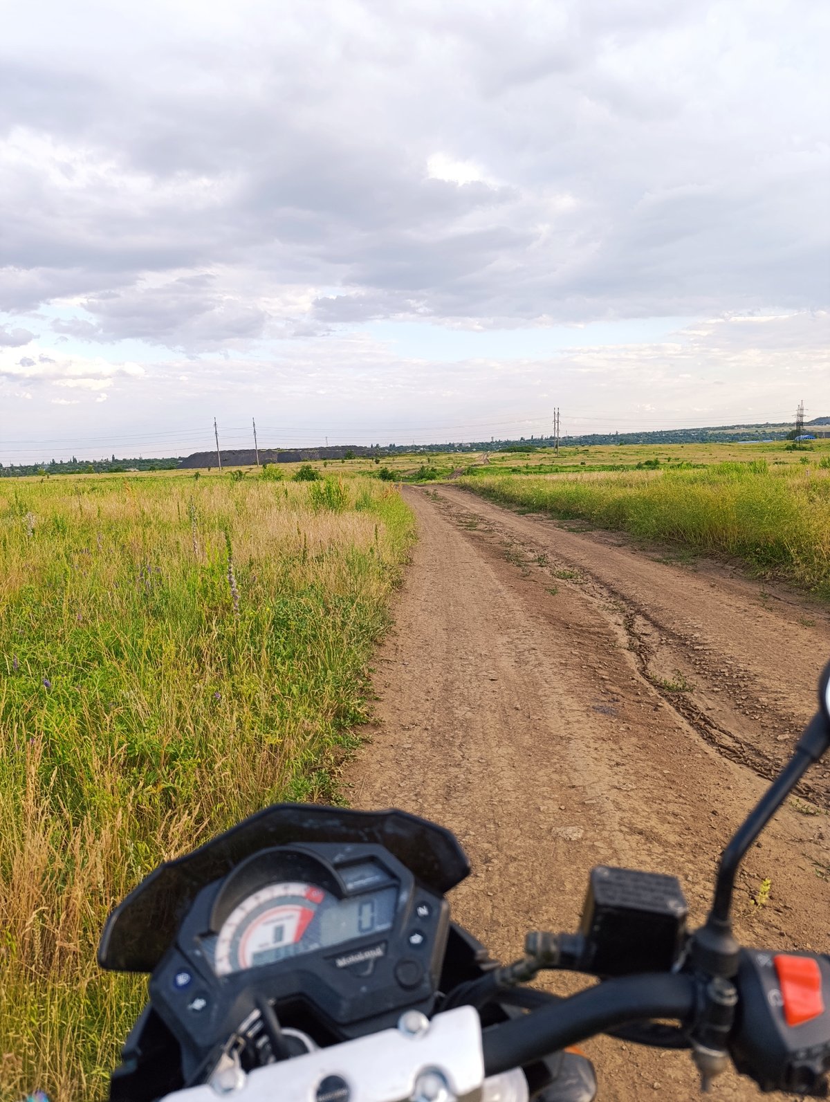 Solo motorcycle ride through open grassland and rural backroads