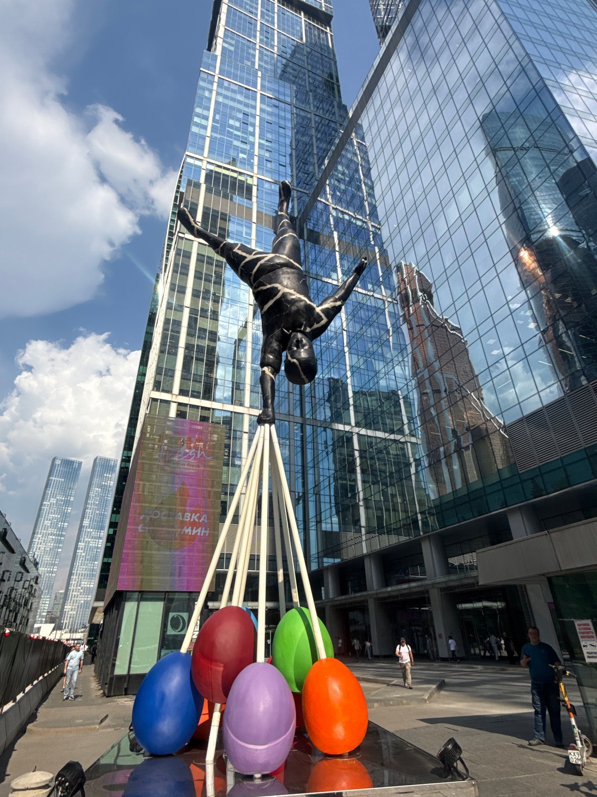 Suspended acrobatic sculpture observed in Moscow public art display