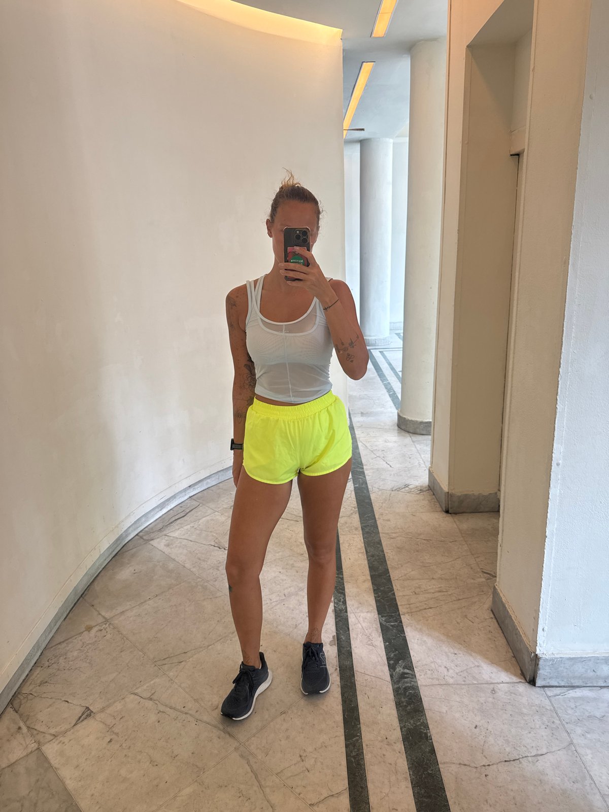 Mirror selfie in a curved white hallway, Tel Aviv