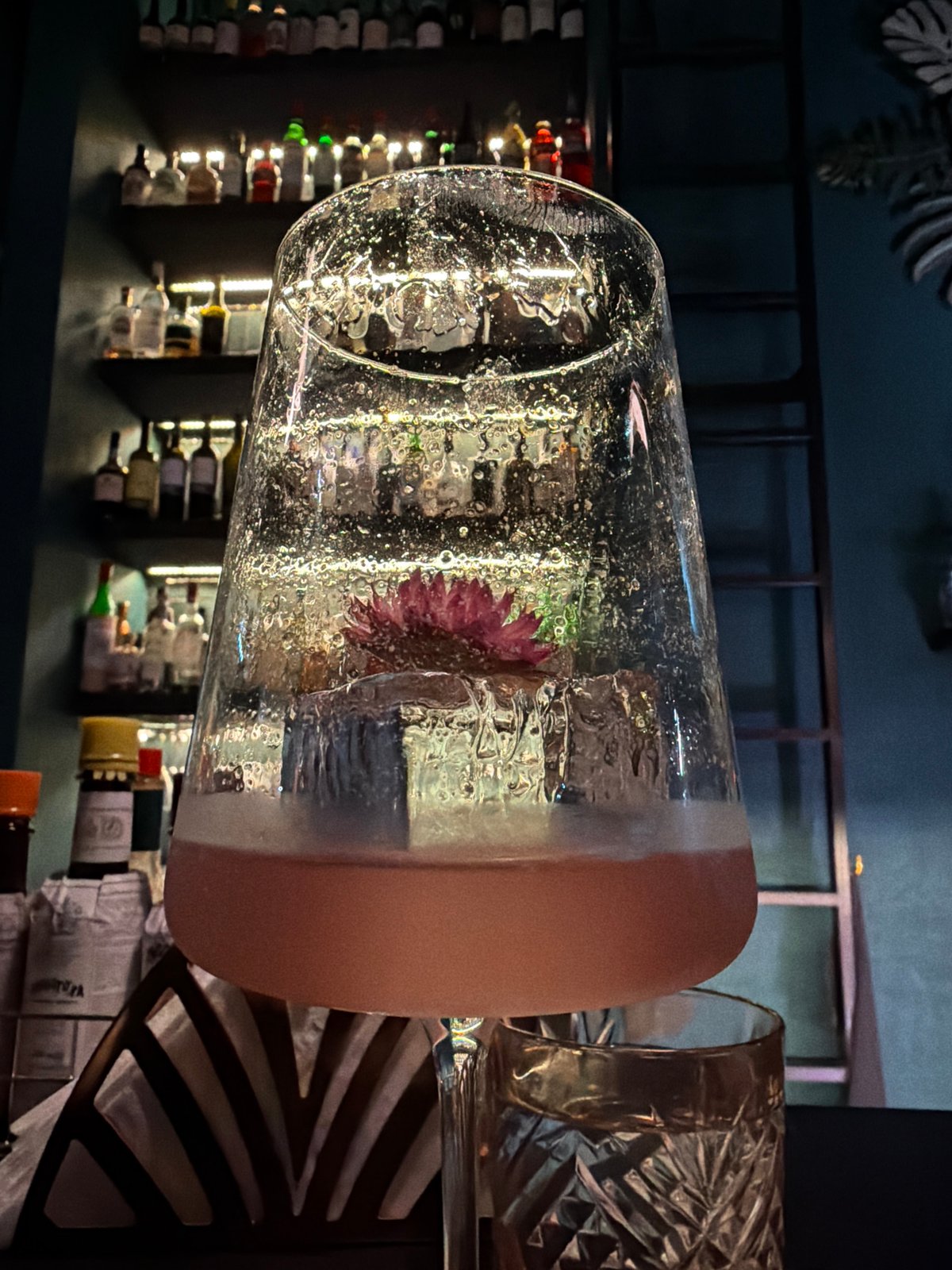 Evening cocktail service documented at dimly lit establishment