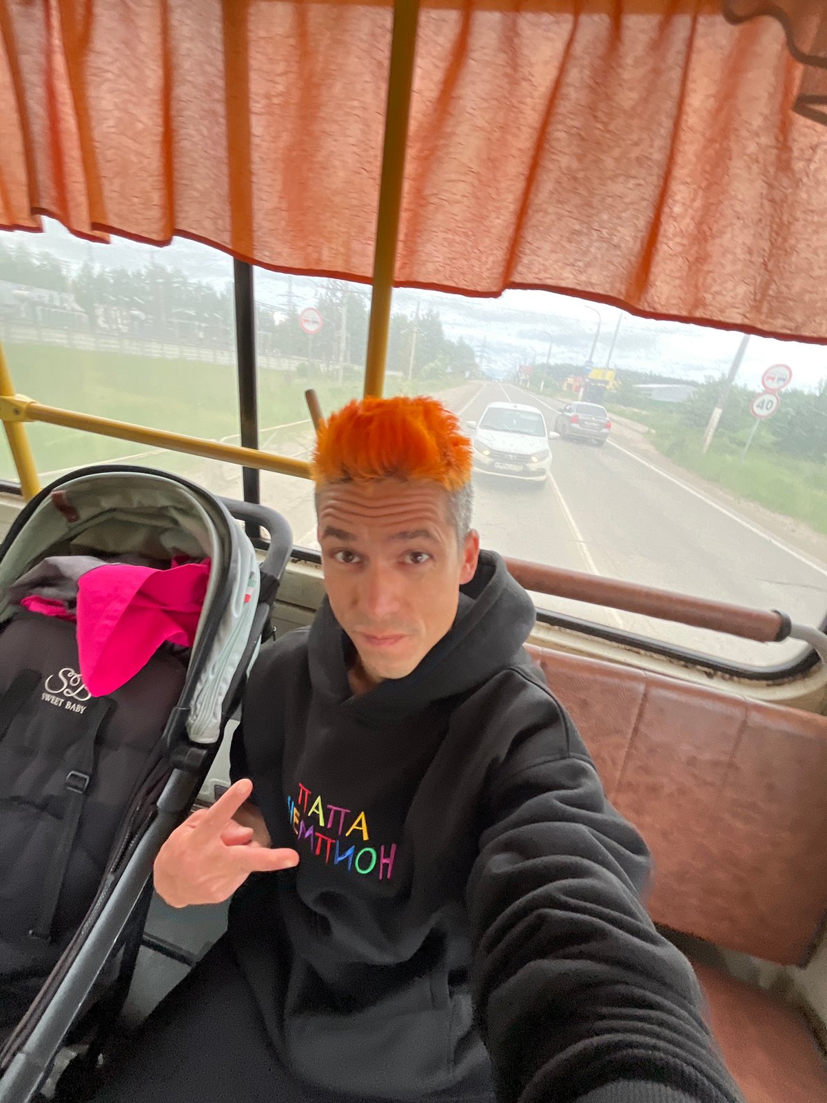 Orange-haired man takes selfie on Chaikovsky public transport