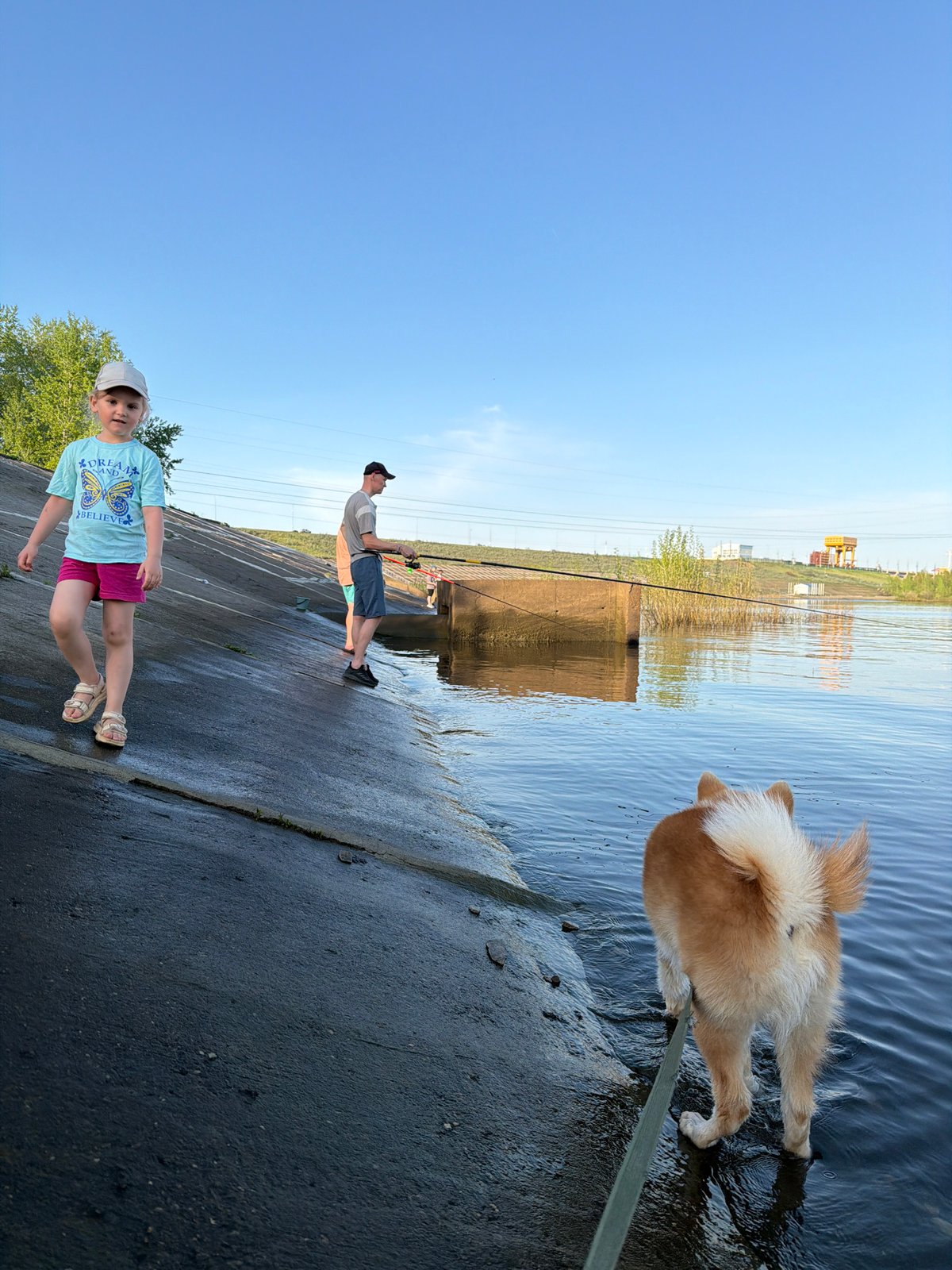 Families enjoy afternoon fishing outing along Kama River in Chaikovsky