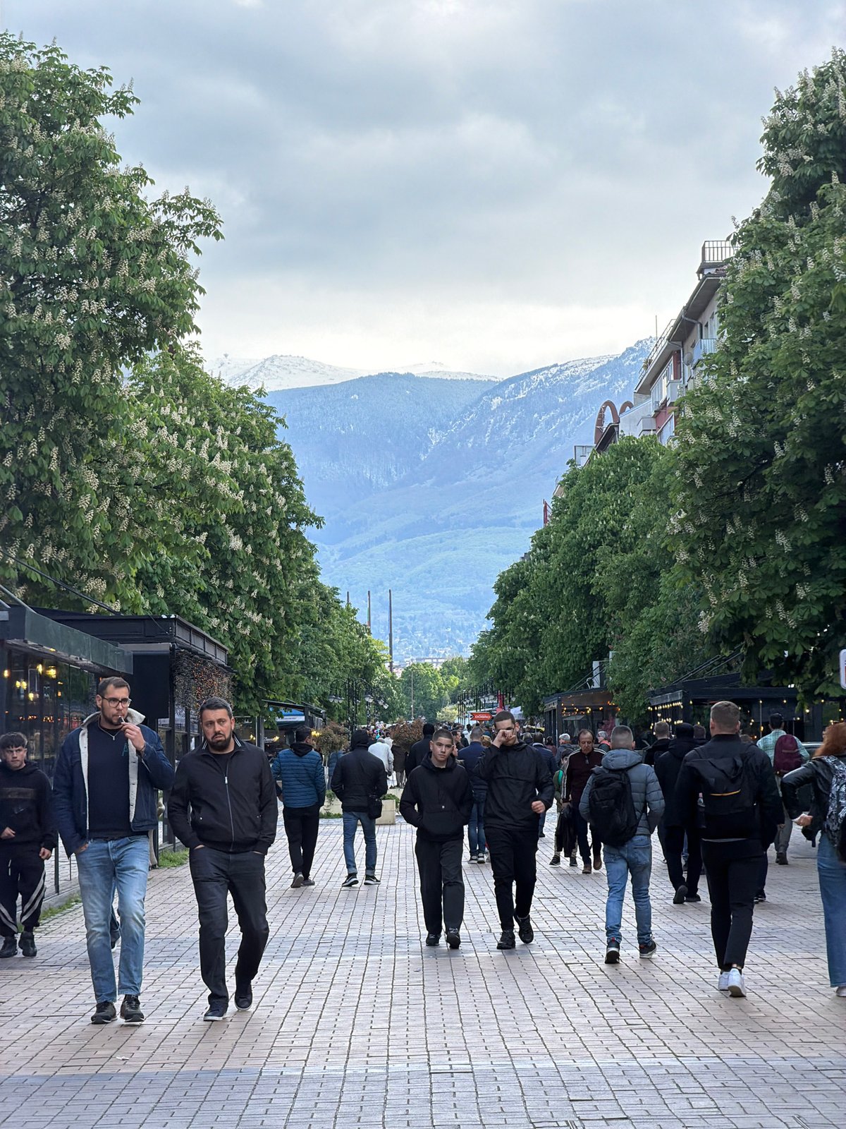 Spring afternoon scenes captured across Sofia include street performers and daily life