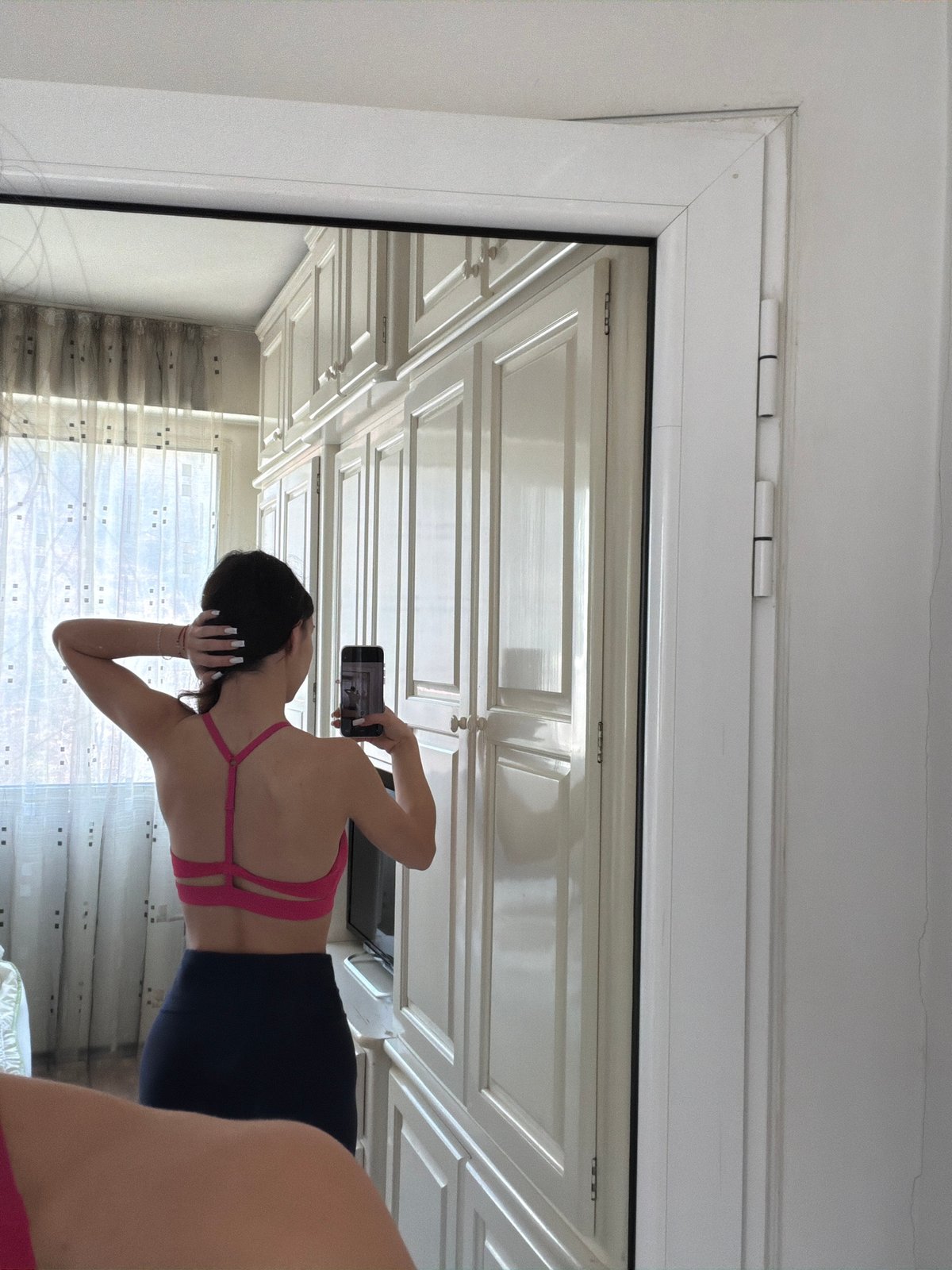 Woman takes mirror selfie in athletic wear in Gabrovo
