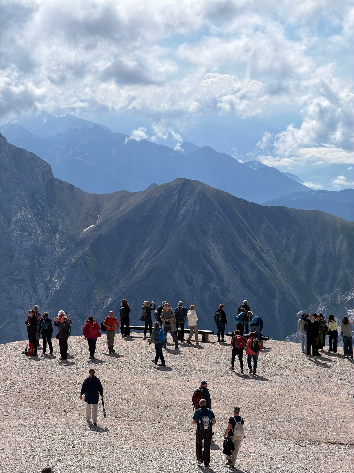 Tourists taking in layered alpine views at a Garmisch-Partenkirchen overlook