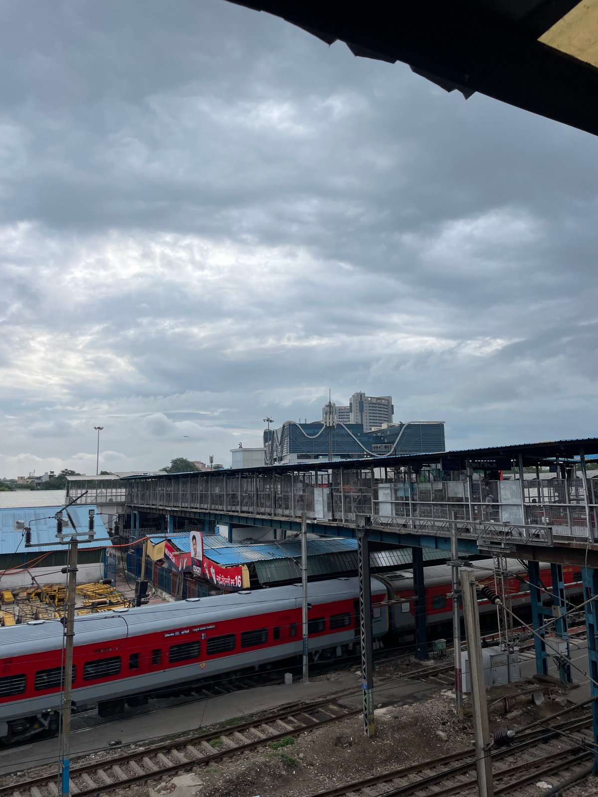 Inside a busy New Delhi railway station on a cloudy morning