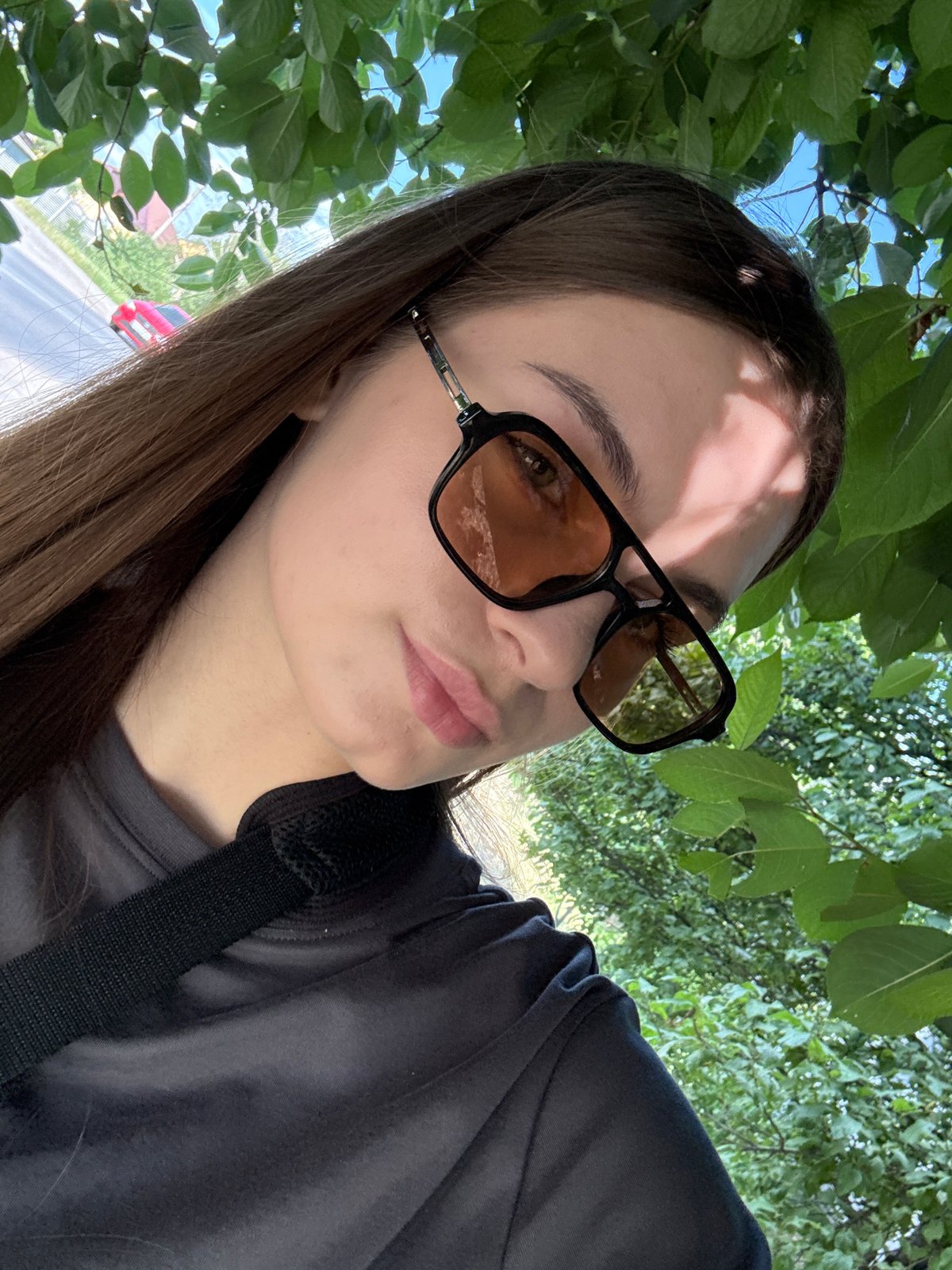 Woman documents sunny afternoon walk through blooming Dnipro neighborhoods
