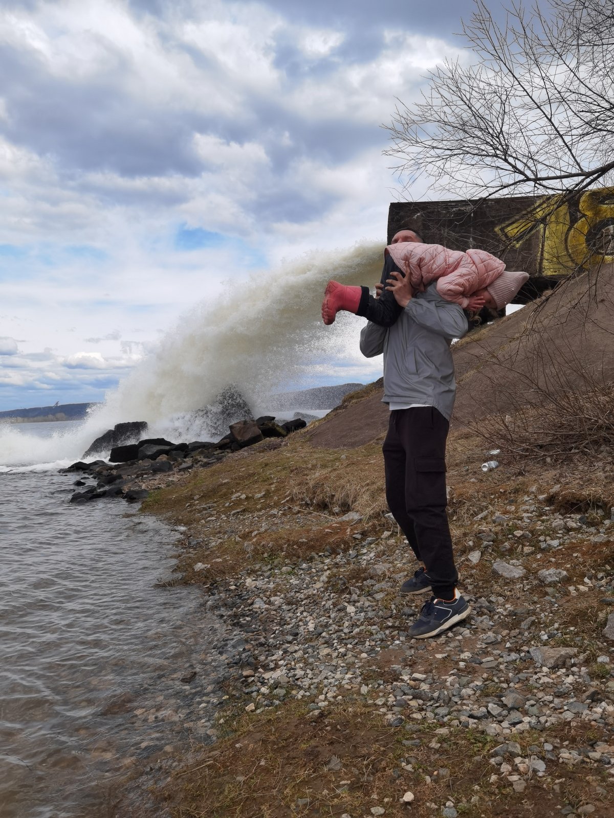 Family visits dramatic water spillway in Chernushka, Russia