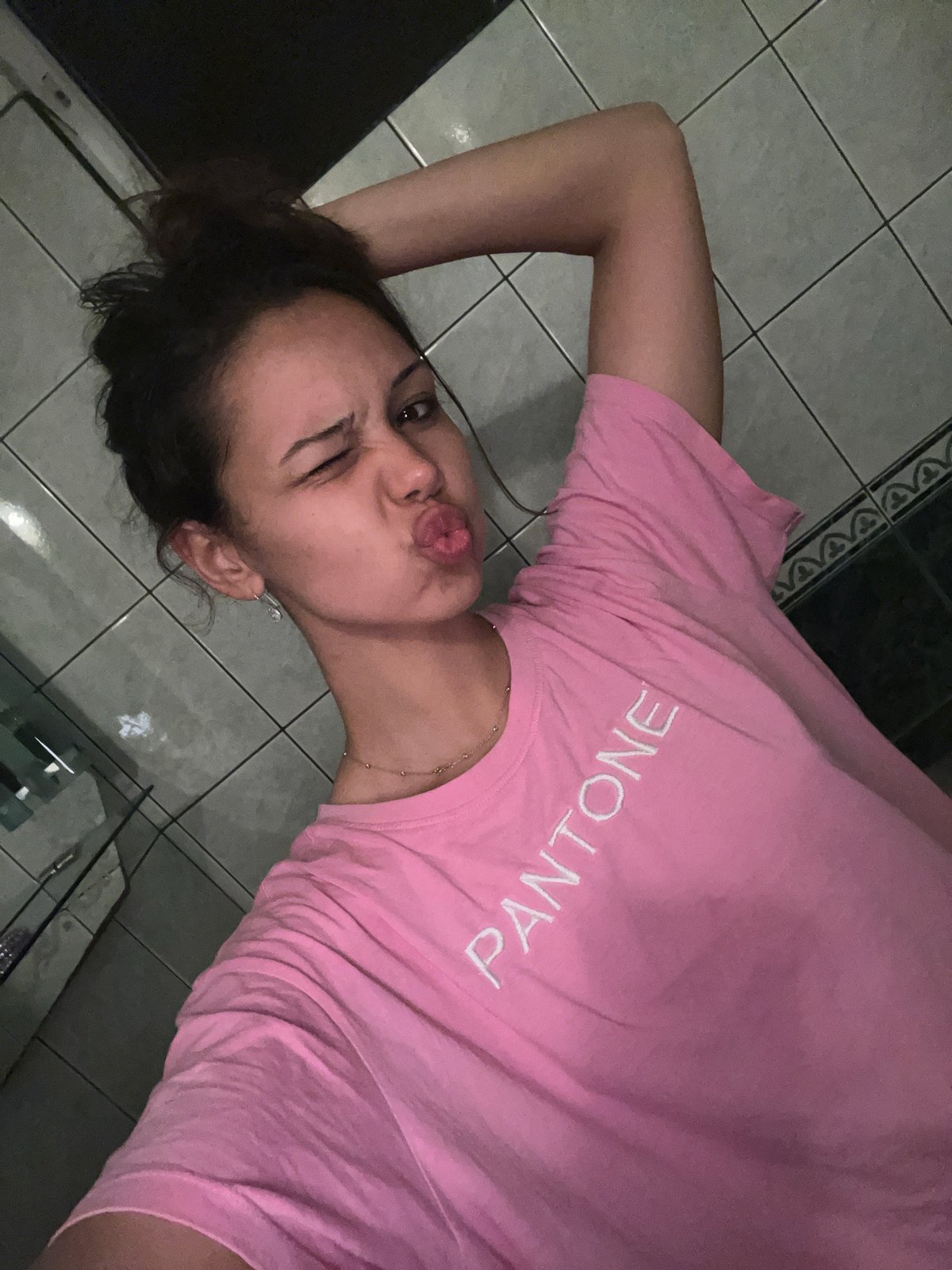 Young woman takes playful selfies during nighttime outing