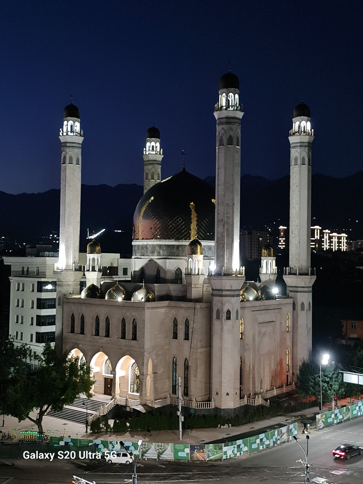 Almaty at dusk: mosque and skyline lit up for the night