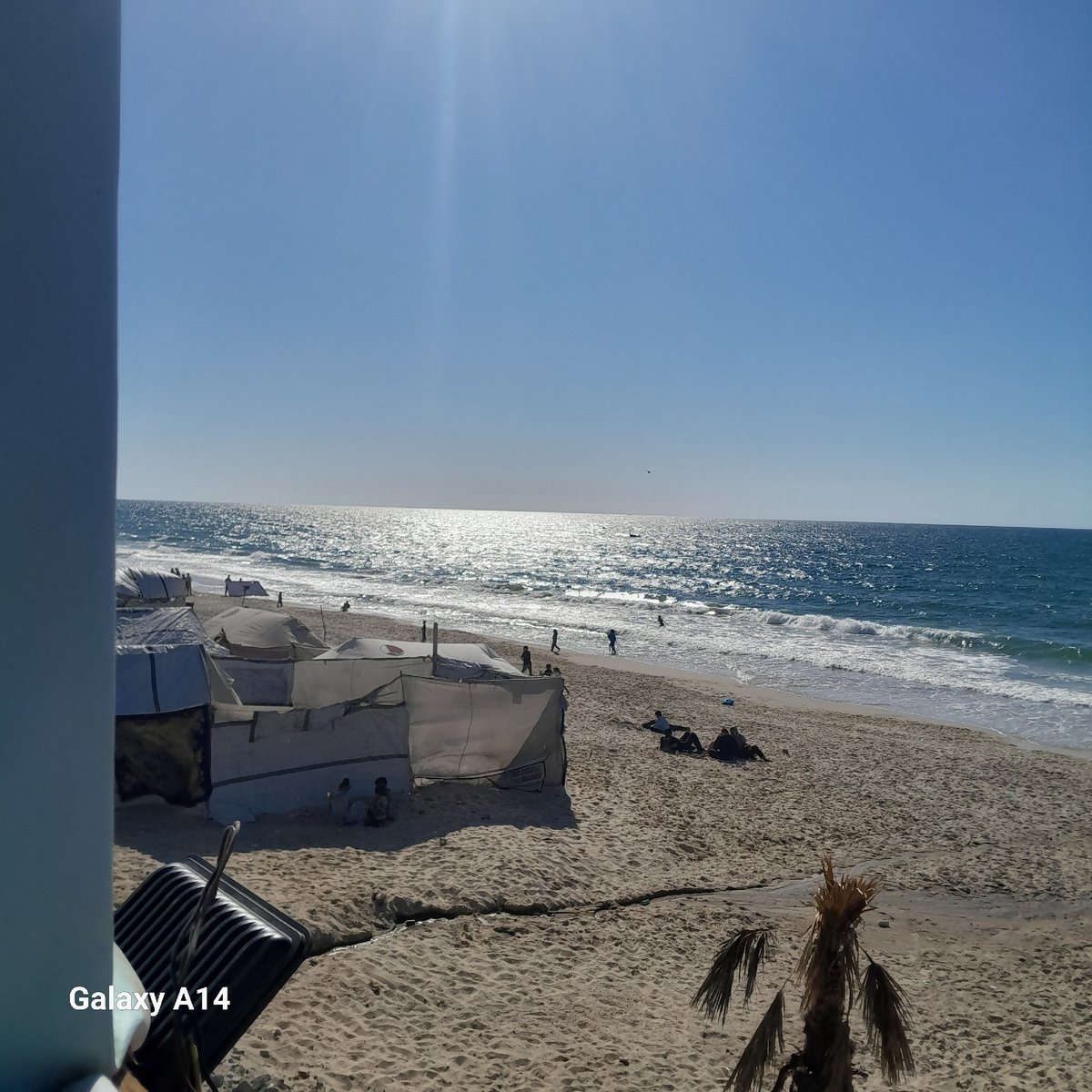 Beach scenes captured showing clear skies, waves, tents
