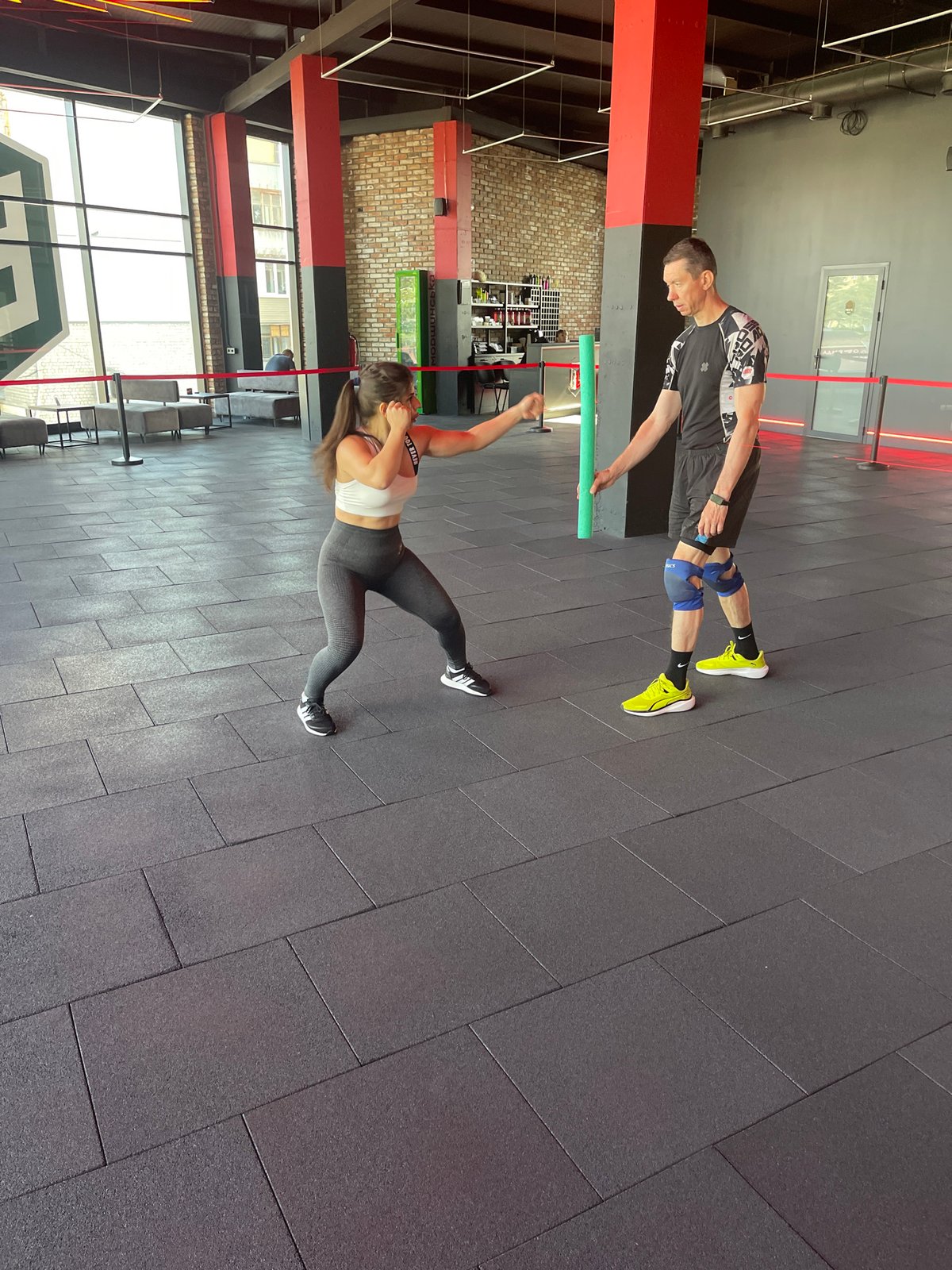 Partner workout session in an industrial-style gym