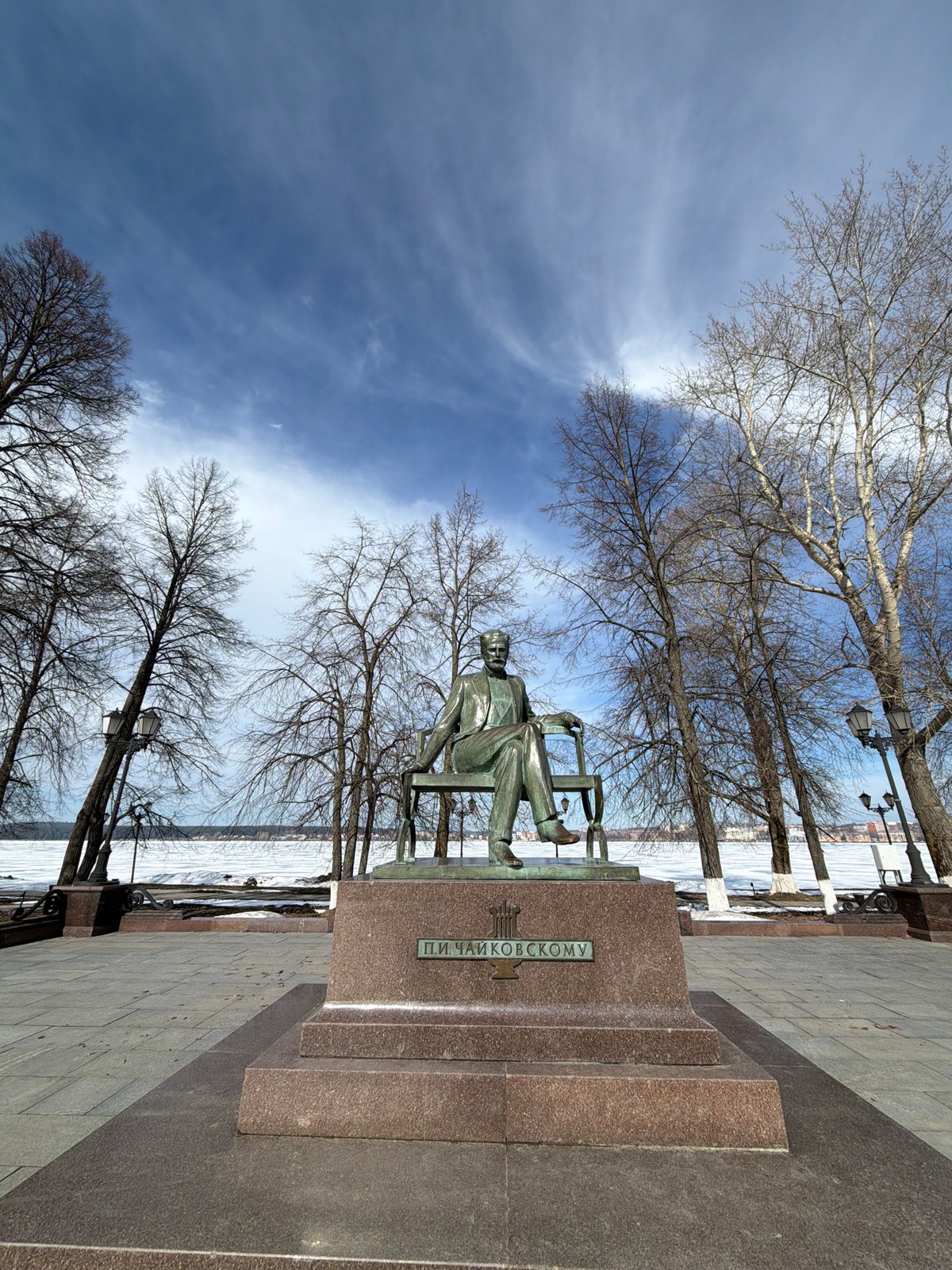 Winter tourism documented in Votkinsk, Russia featuring Tchaikovsky statue