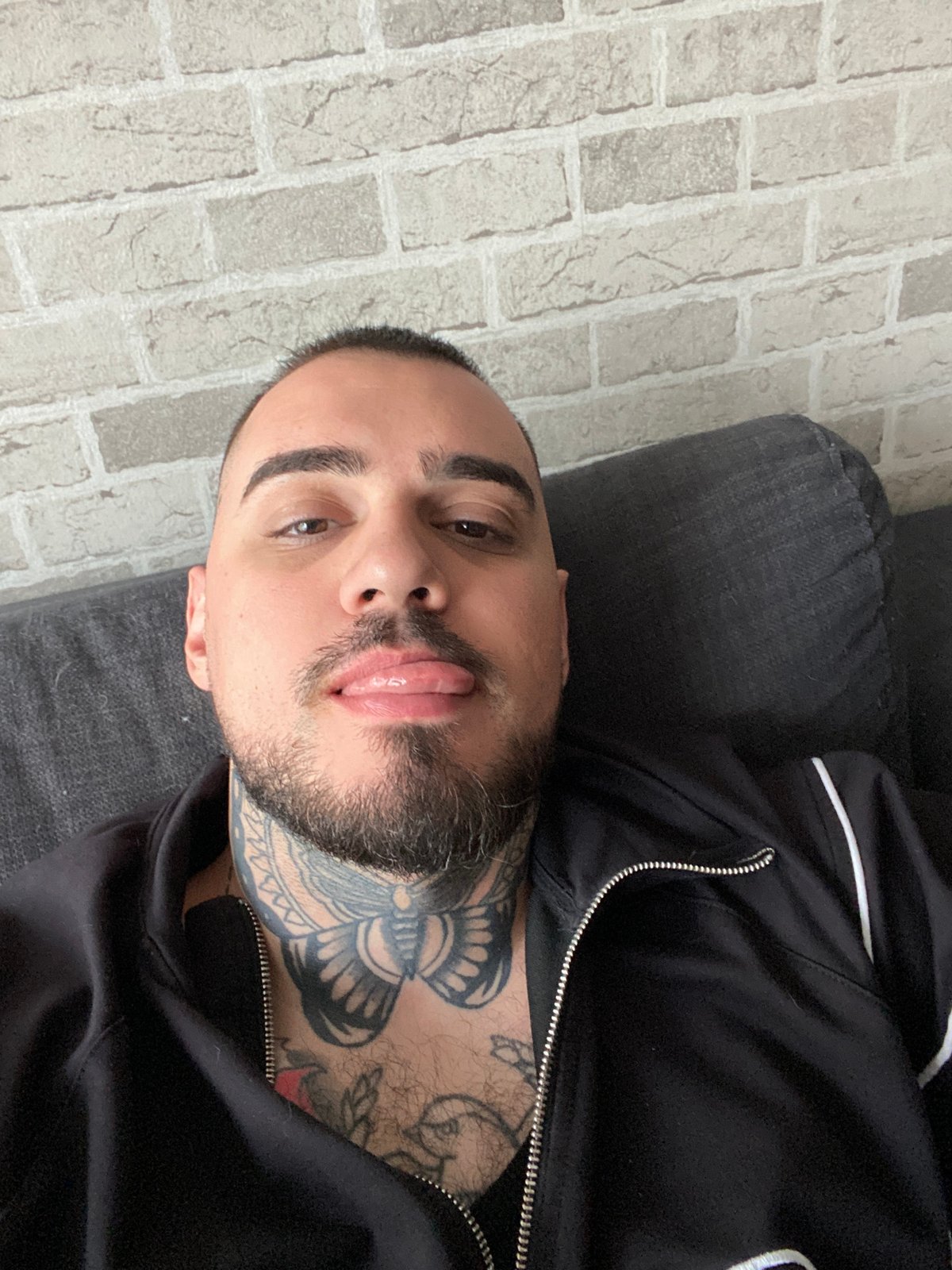 Man rests on sofa in Sofia apartment, anime plays