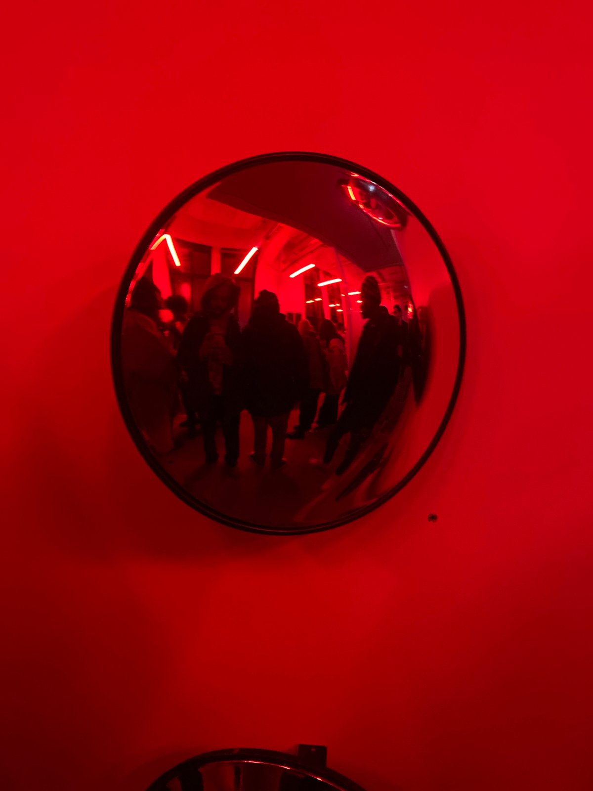 Red-lit architectural space documented in Paris with Eiffel Tower views