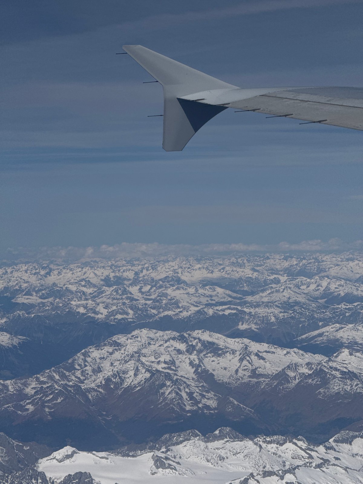 Aerial view of snow-covered mountains captured over northern Italy