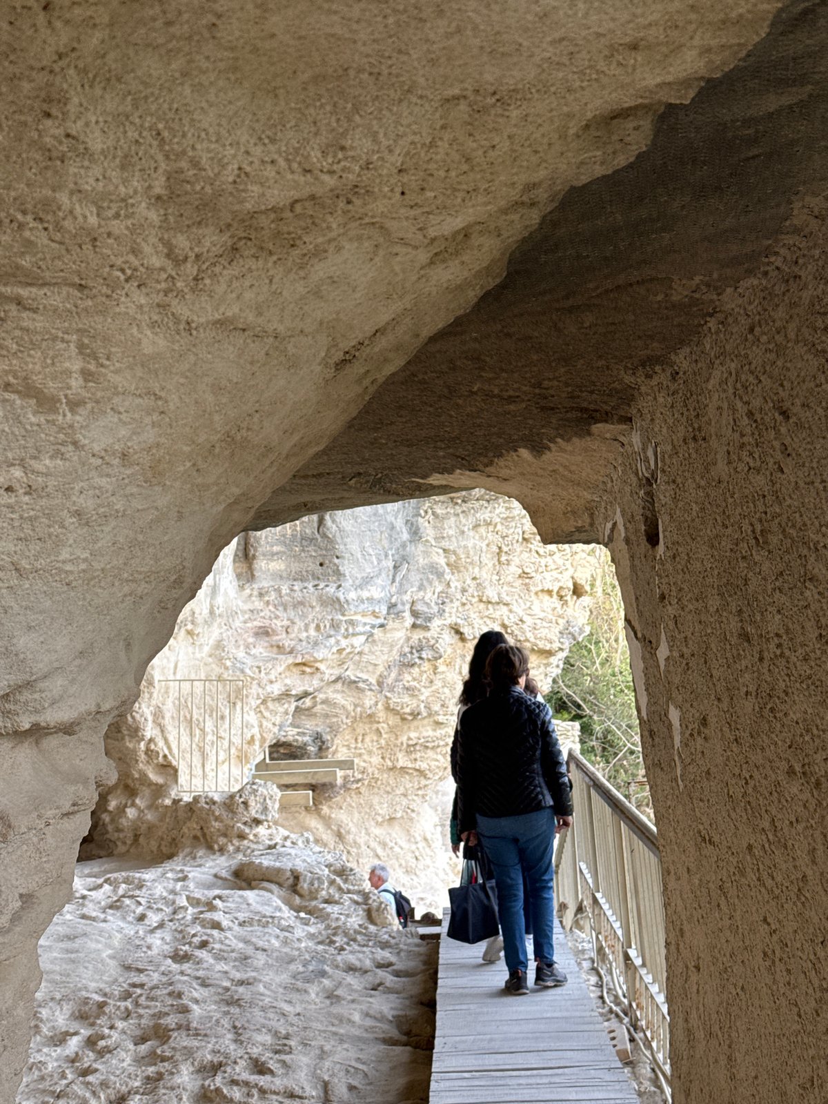 Visitor documents ancient rock formations at Aladzha Monastery, Bulgaria