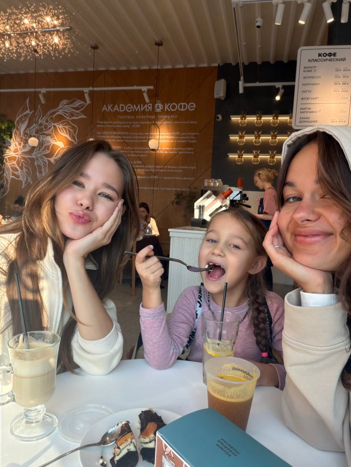 Teen and child share morning cafe visit in Krasnoyarsk