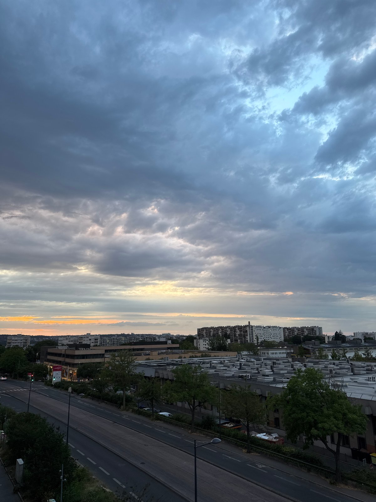 Dramatic dusk clouds settle over an urban skyline
