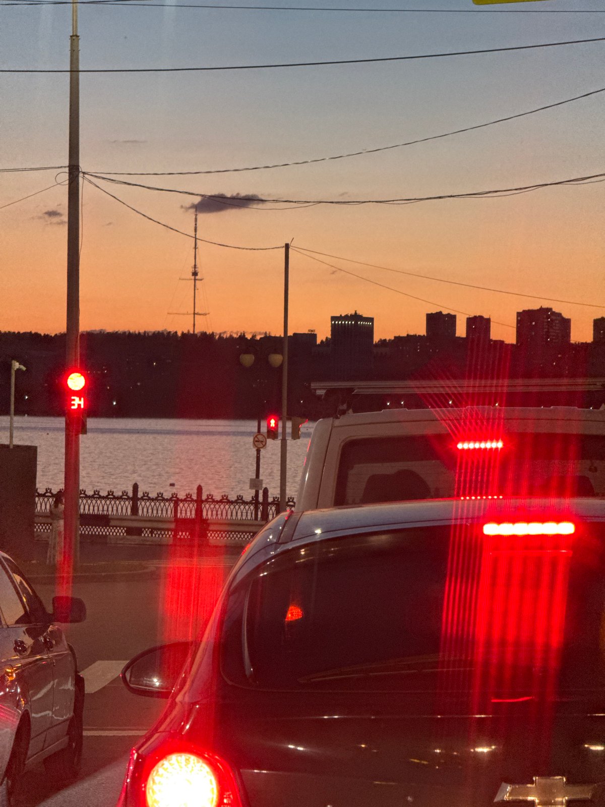 Rush hour pause at a riverside intersection in Izhevsk at dusk