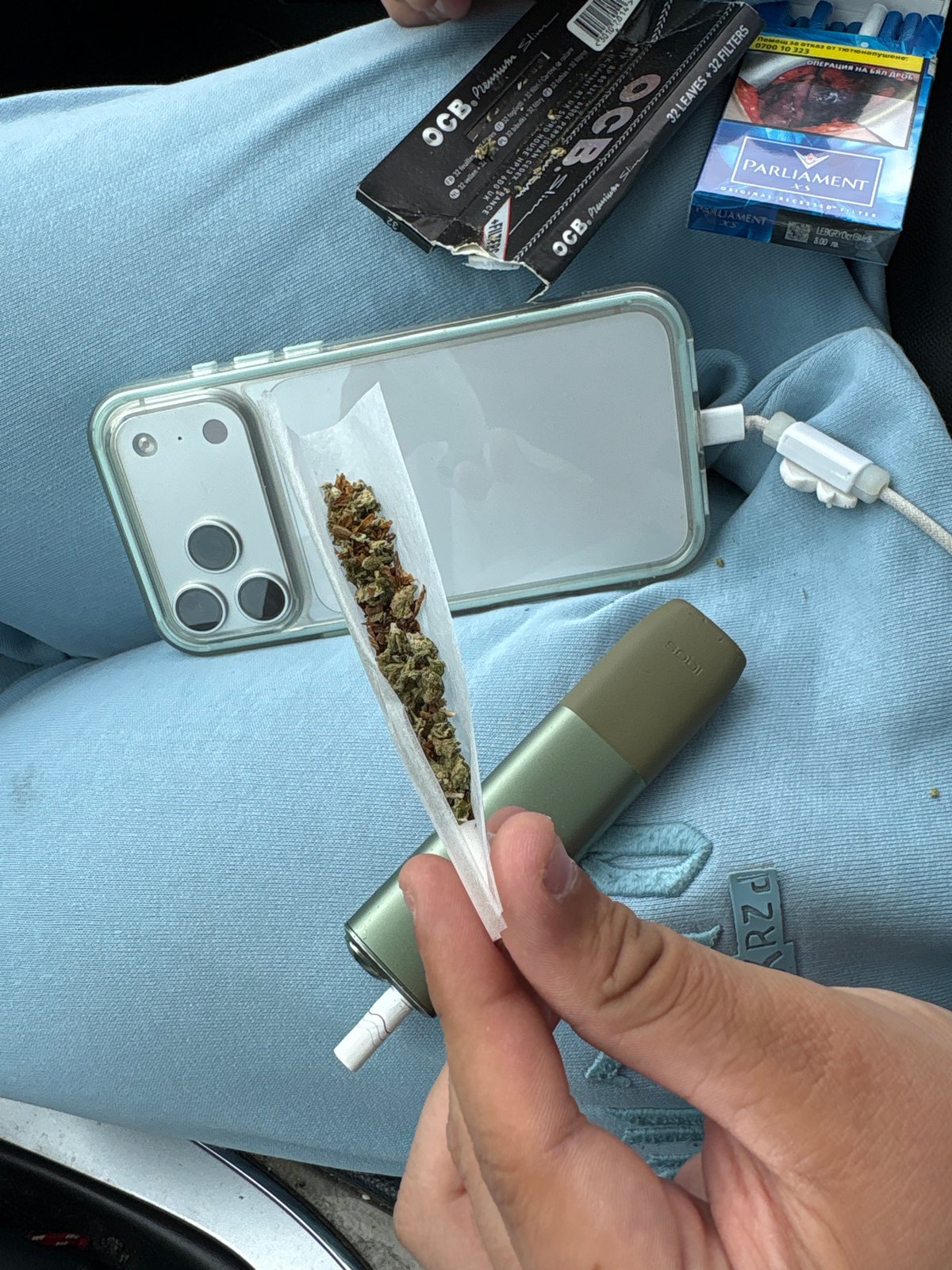 Cannabis rolling and car passenger observed at same location