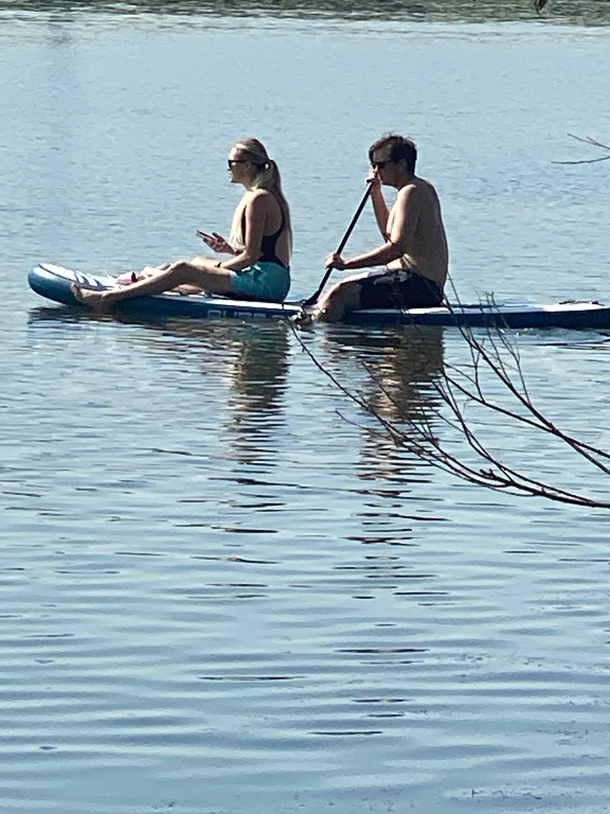 Paddleboards, motorboats, and ducks share a Novokuznetsk waterway