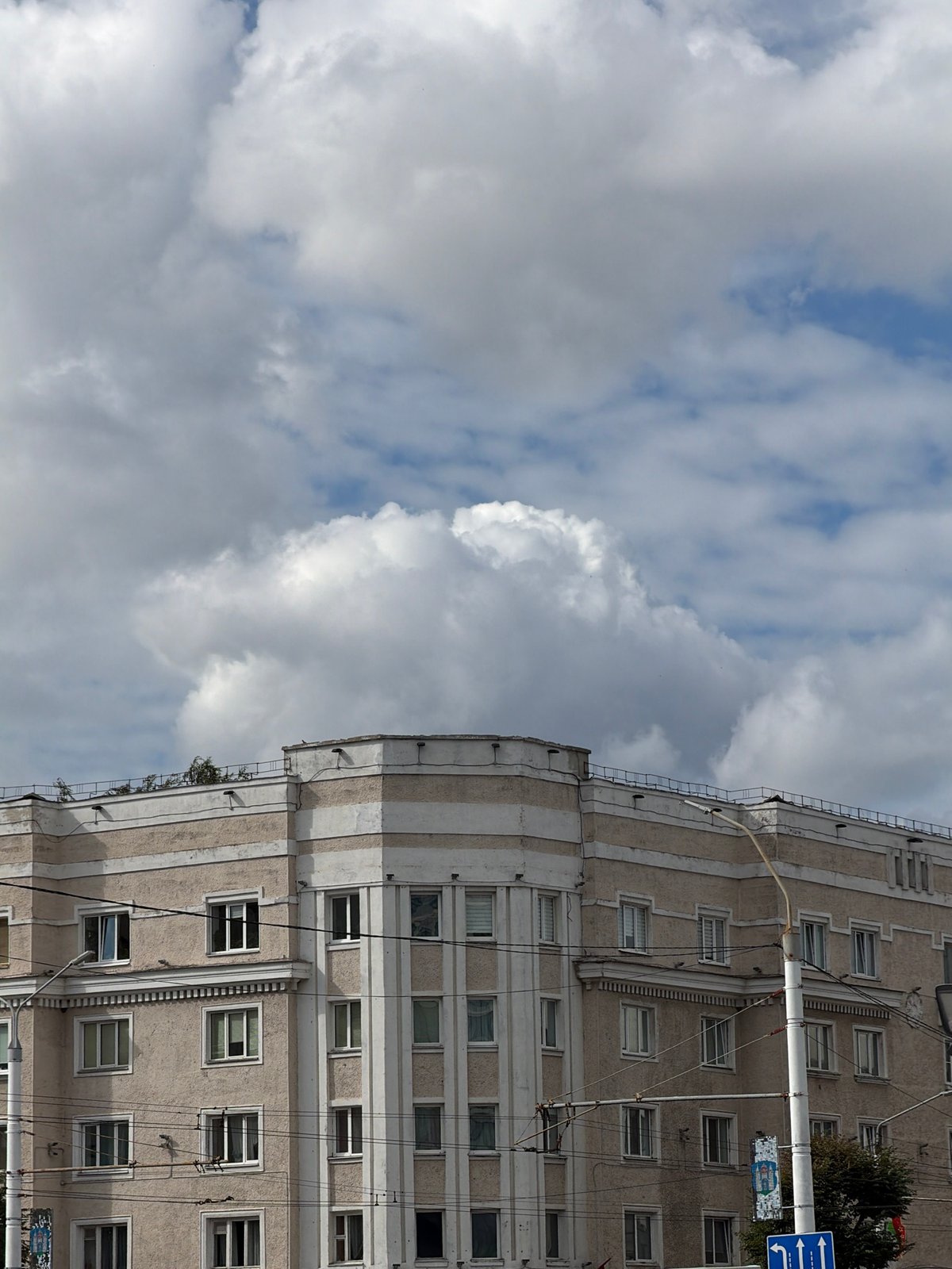 Afternoon in a Mahilyow plaza, pigeons and modern buildings